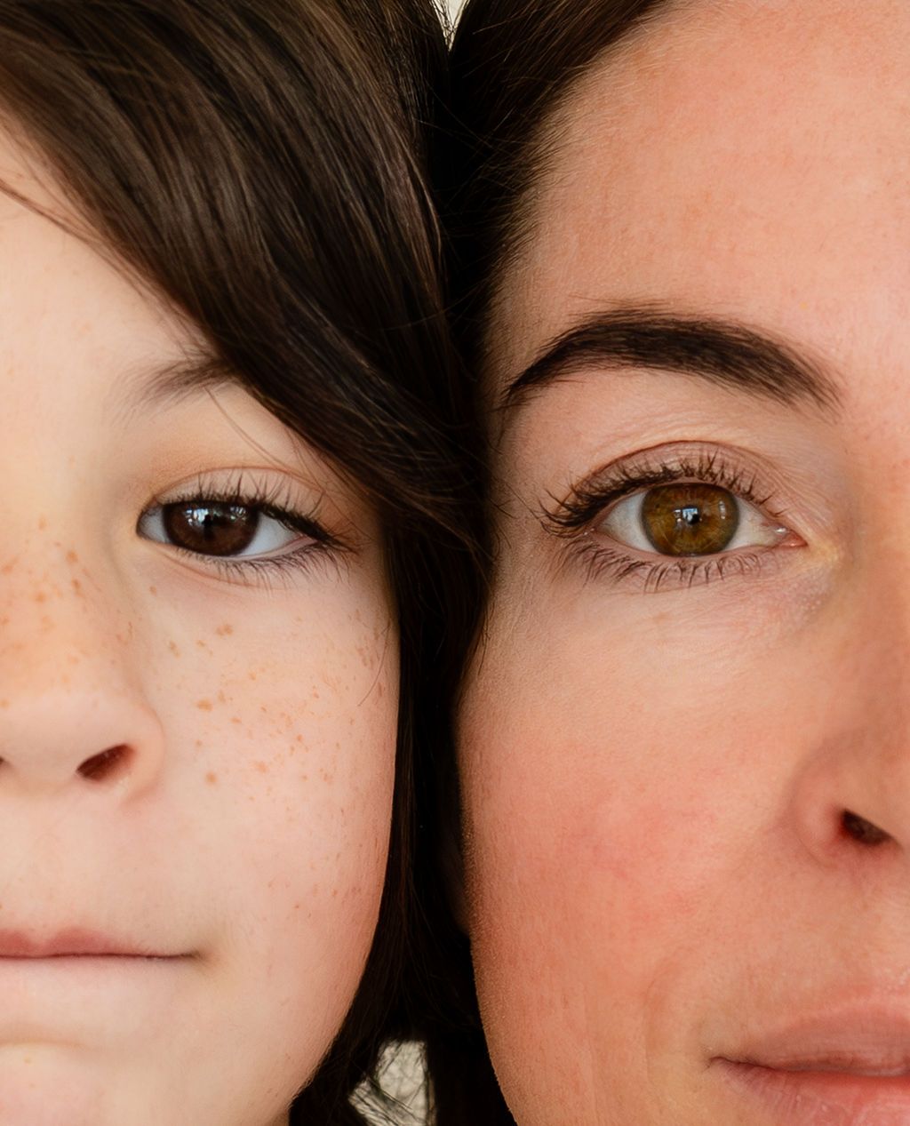 Details of a mother's eyes with her young son's eyes close together