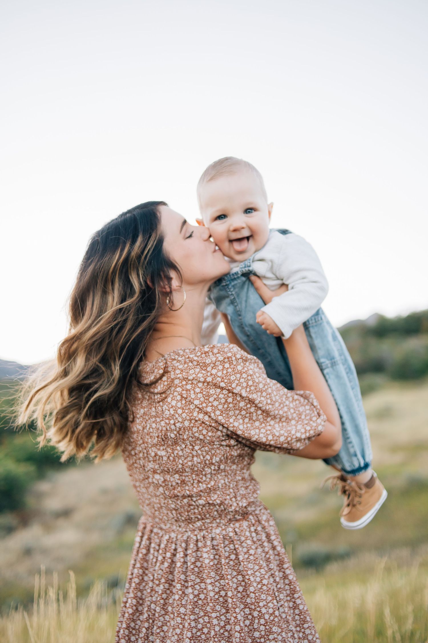 A mom kissing her baby during an outdoor family photo session in Northern Utah