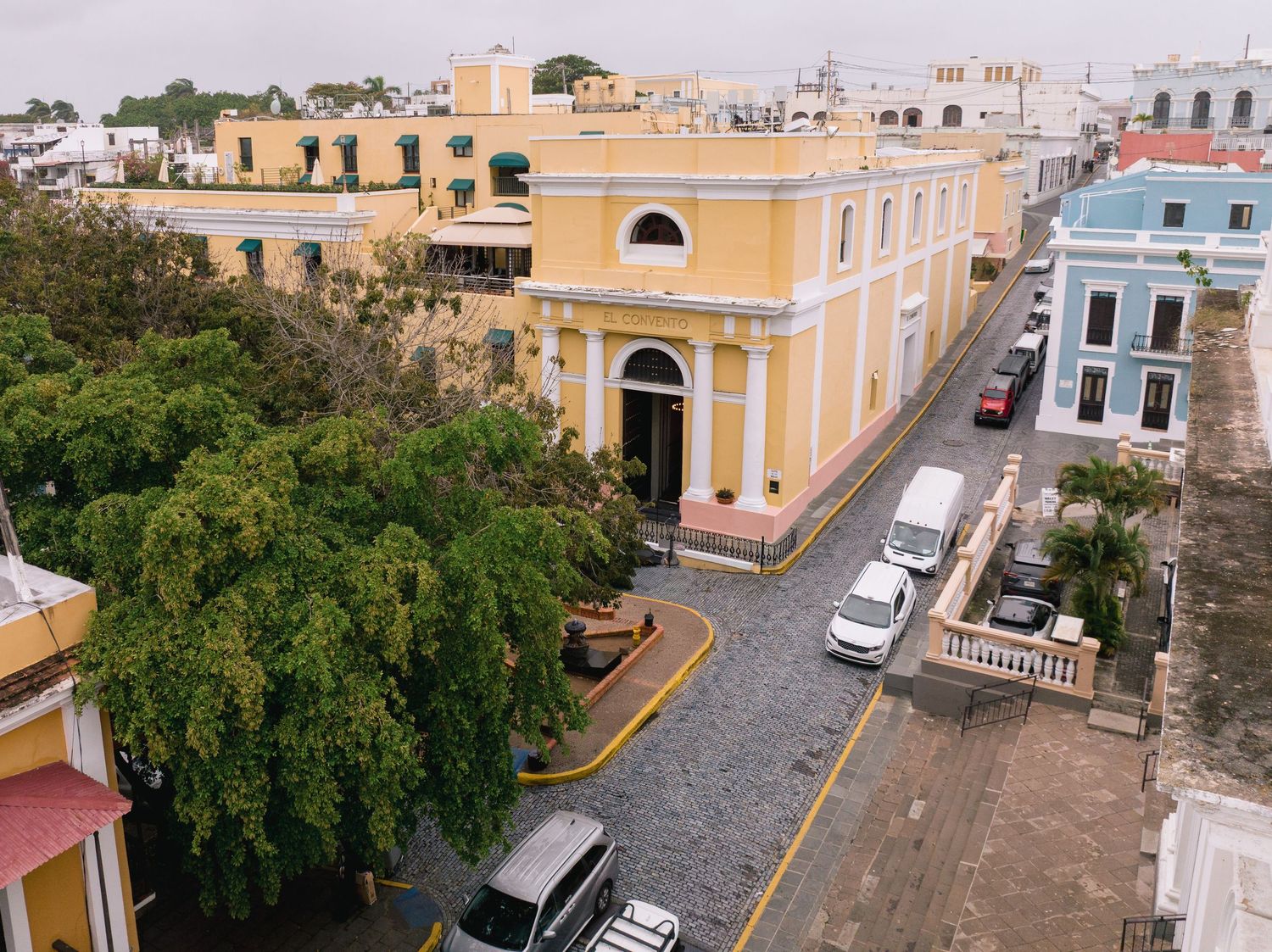 Aerial view of colorful colonial buildings lining a cobblestone street in Old San Juan, Puerto Rico.