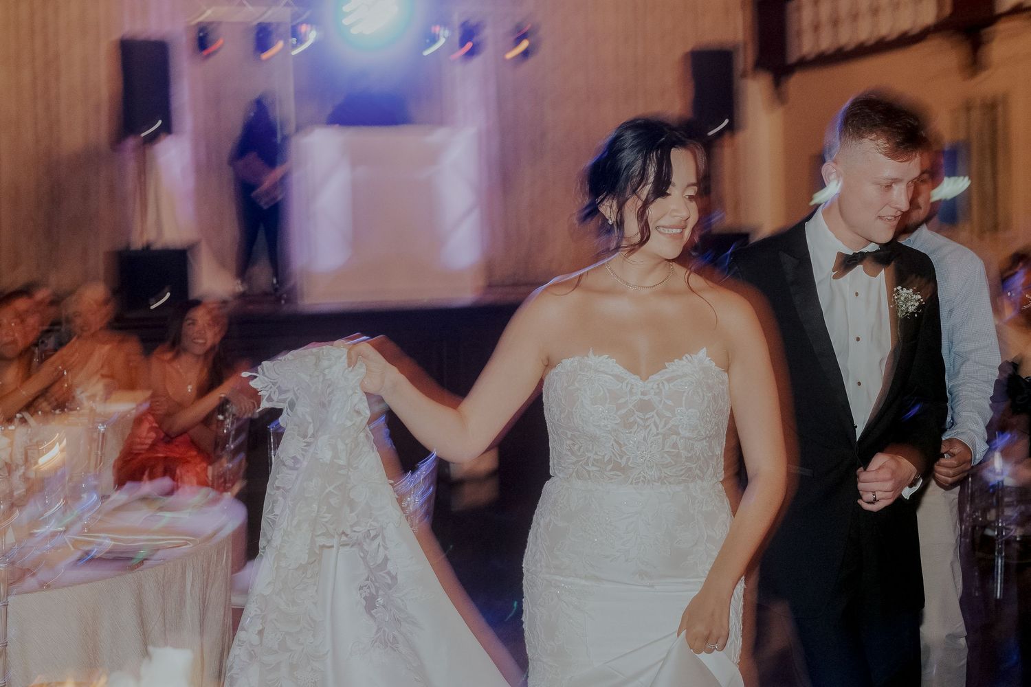 Bride and groom share their first dance in a beautifully lit wedding reception venue.
