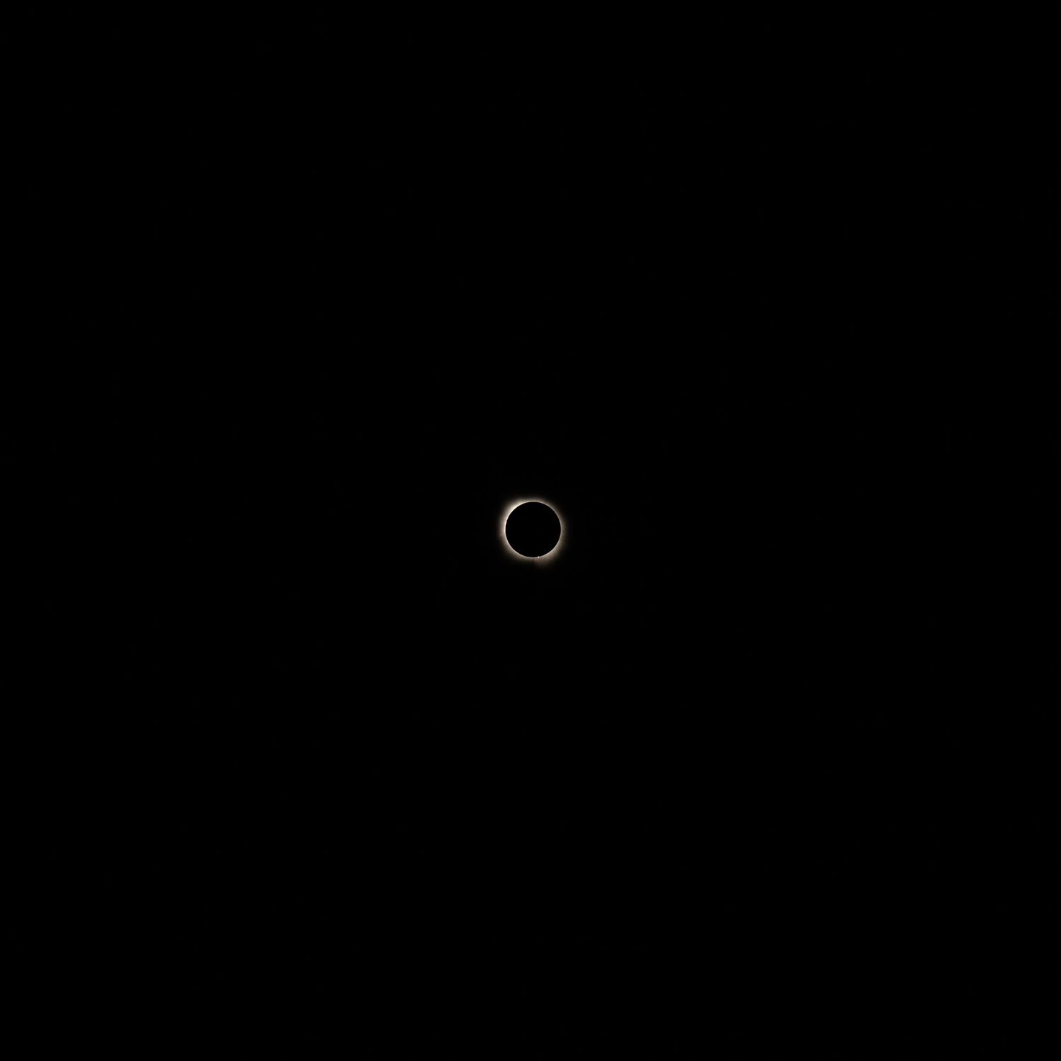 A rare annular solar eclipse ring of fire visible against a completely dark sky.