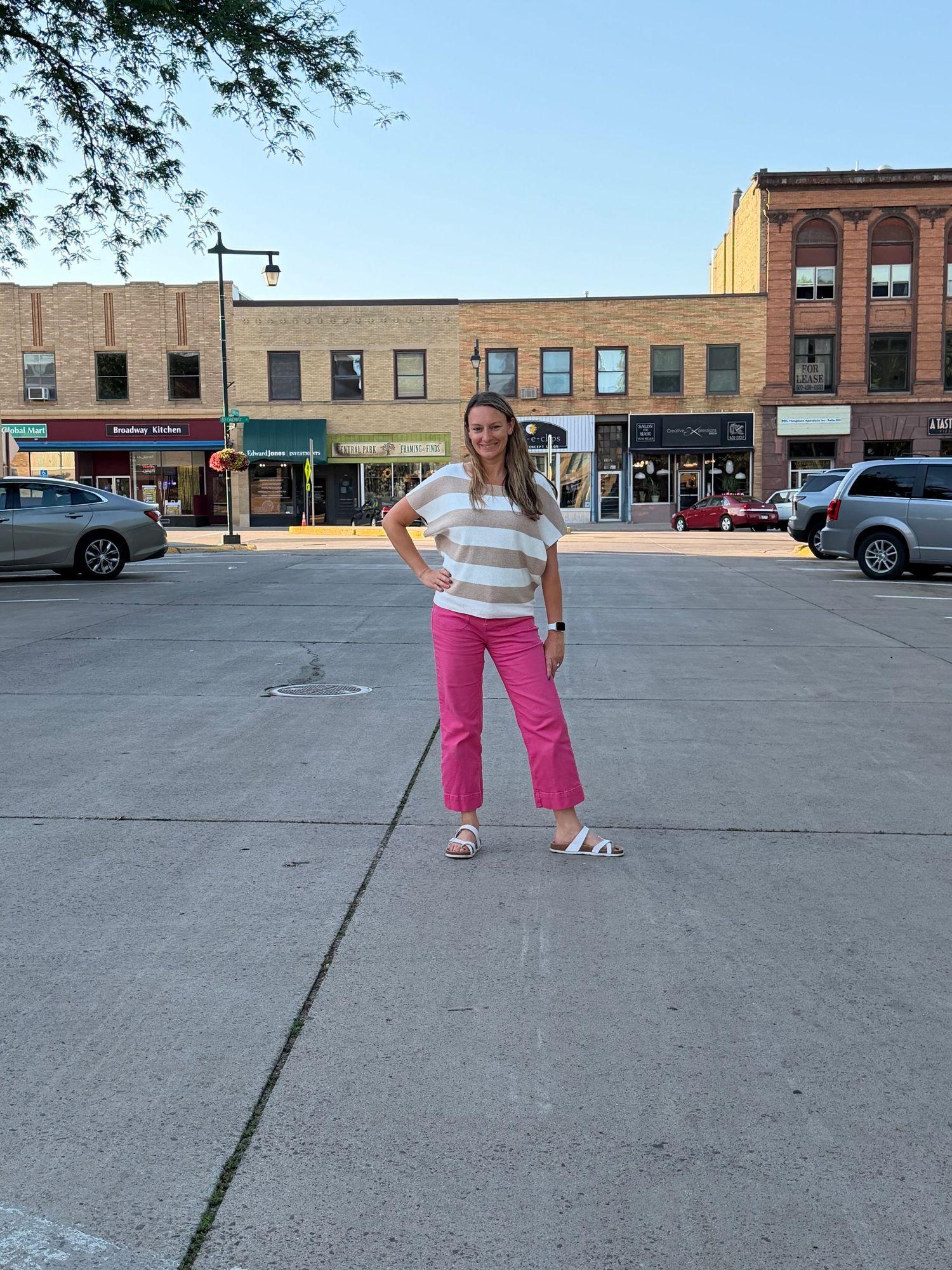 Morgan Bjorklund standing in a small downtown street encouraging small business owners to enter the Birthday Launch Contest
