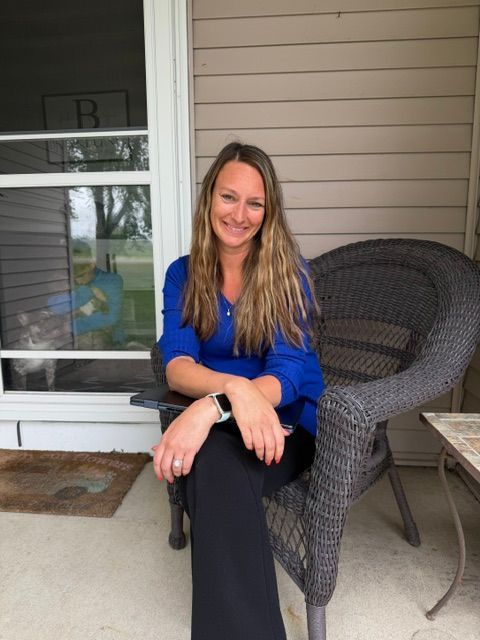 Morgan from Silver Lining Marketing sitting on a porch in Southern Minnesota, offering creative services for small businesses.