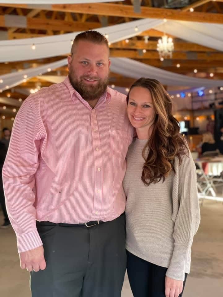 Morgan and her husband Jake standing indoors under warm wooden beams, representing the family foundation & support behind Silver Lining