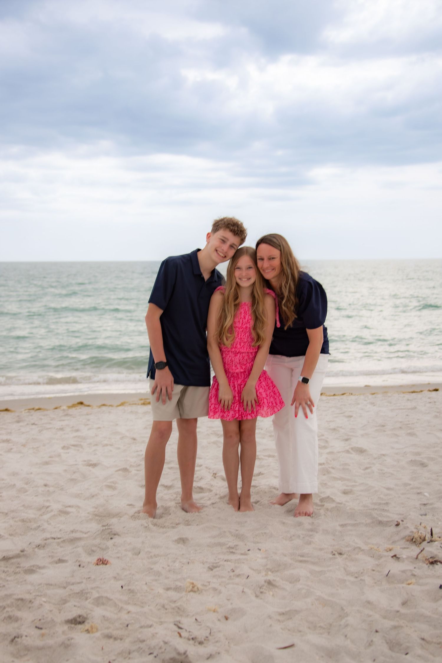 Morgan with her family standing on a sandy beach, reflecting the heart and personal story behind Silver Lining Marketing.