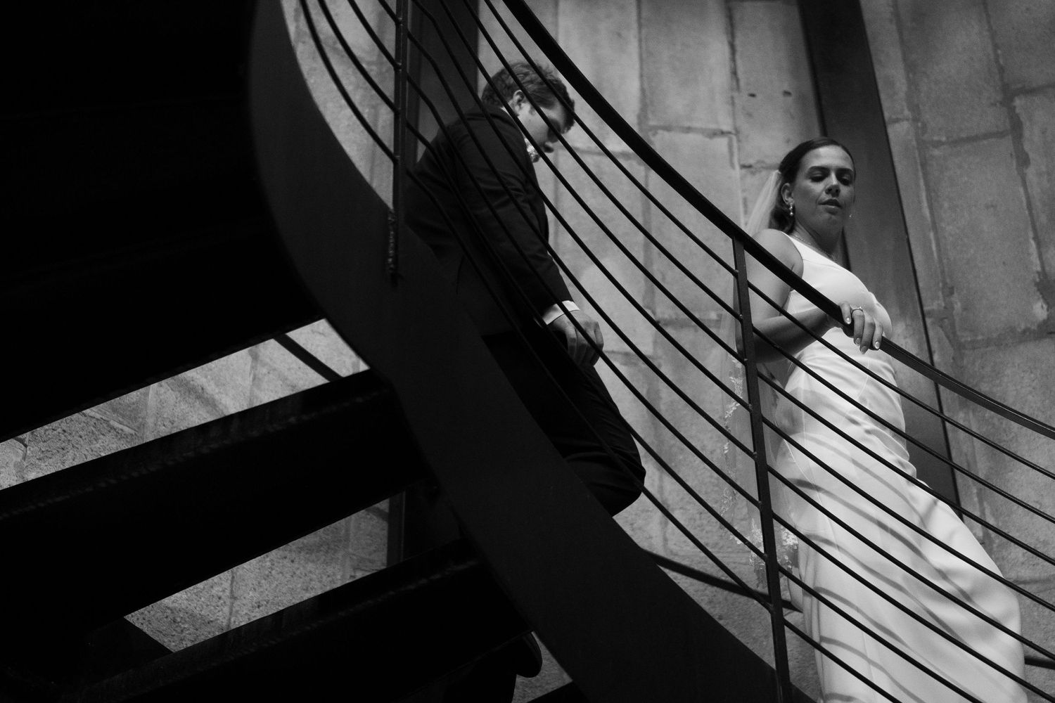 A wedding couple before the ceremony walk down a silo staircase in Scottsville, Virginia.