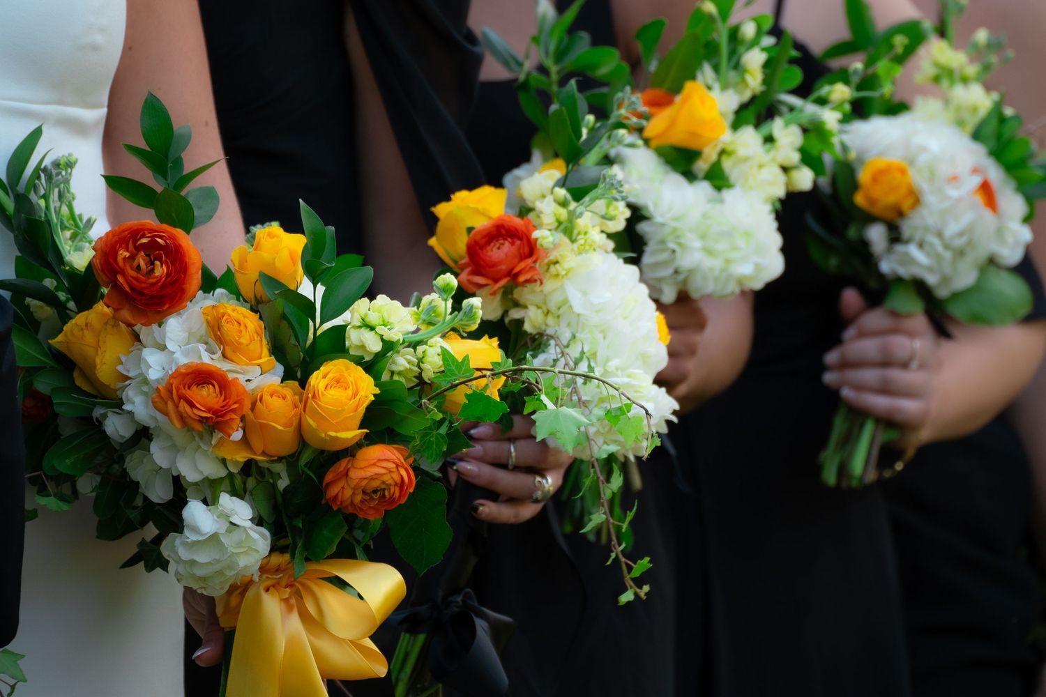 A wedding party holds flower bouquets before  a wedding ceremony in Scottsville, Virginia.