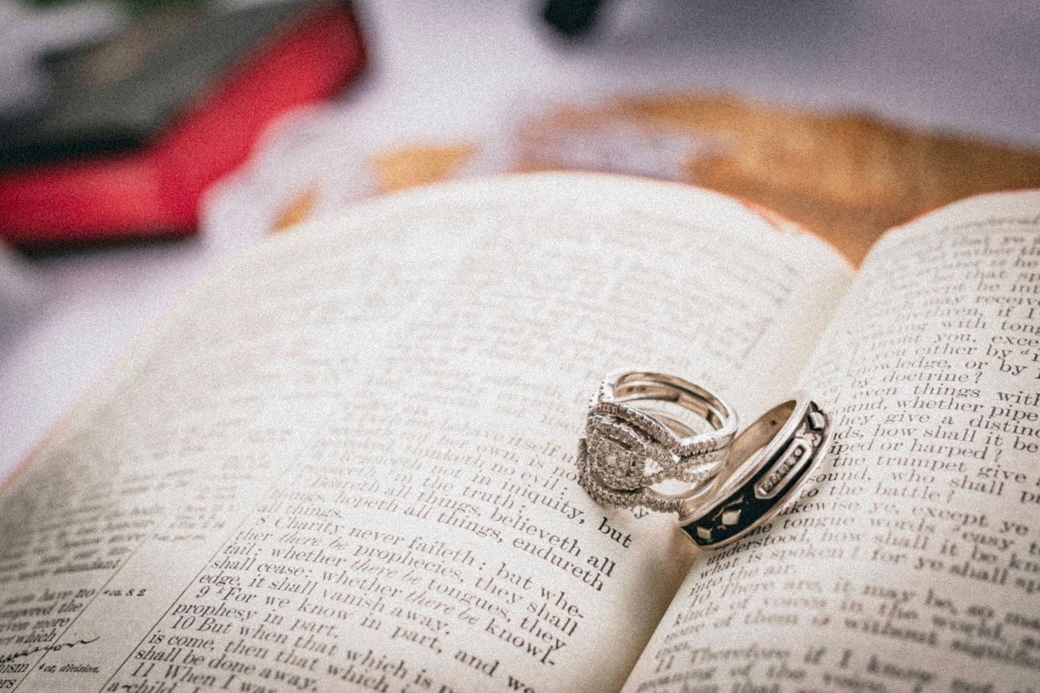 Two diamond rings resting on an open Bible, symbolizing faith and marriage commitment.