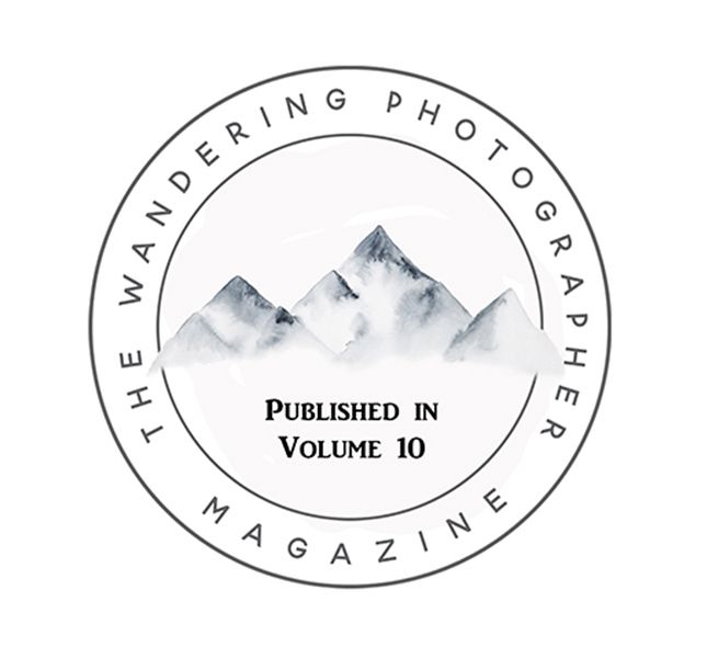 The Wandering Photographer Magazine Published in Volume 10 circular badge with watercolor mountains.