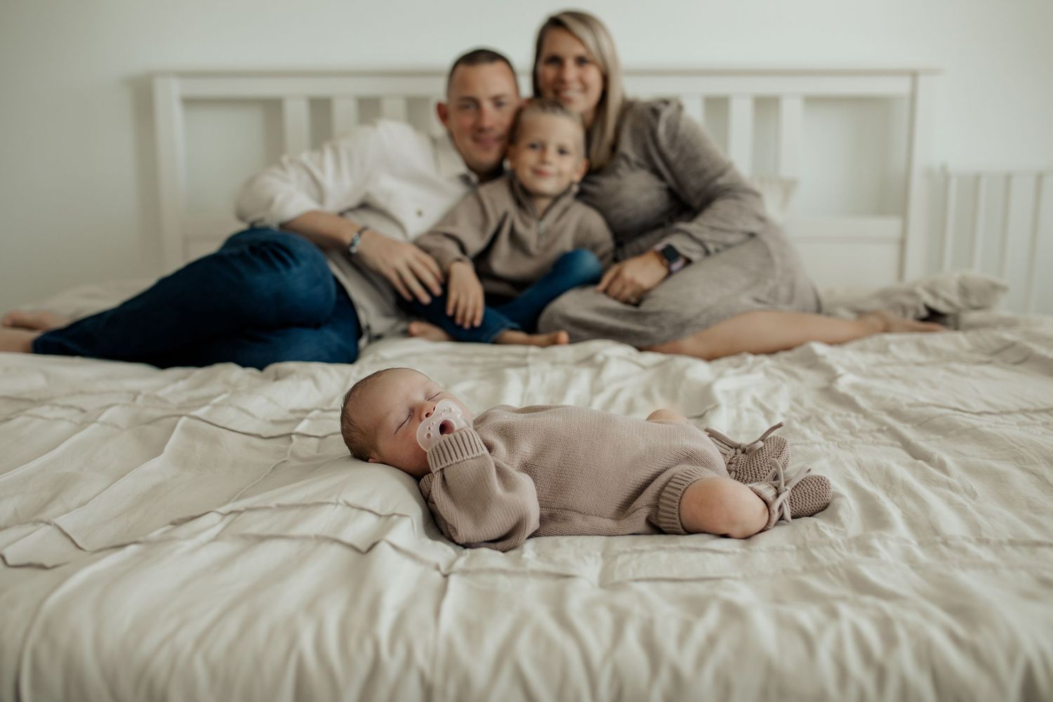 A series of tender family moments captured on a white bed showing relaxation and bonding together.
