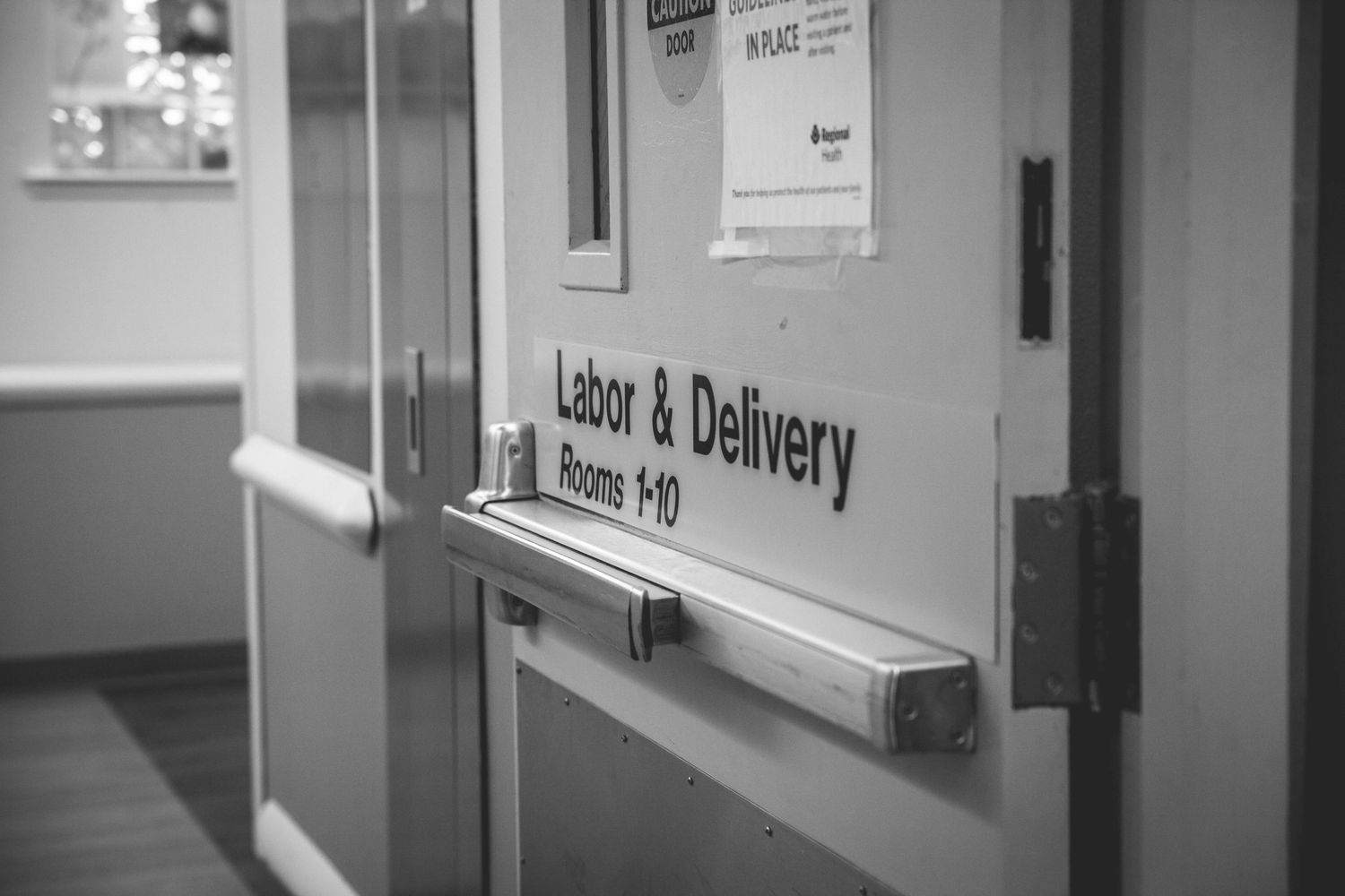 Black and white photo of Labor and Delivery hospital door sign for rooms 1-10.