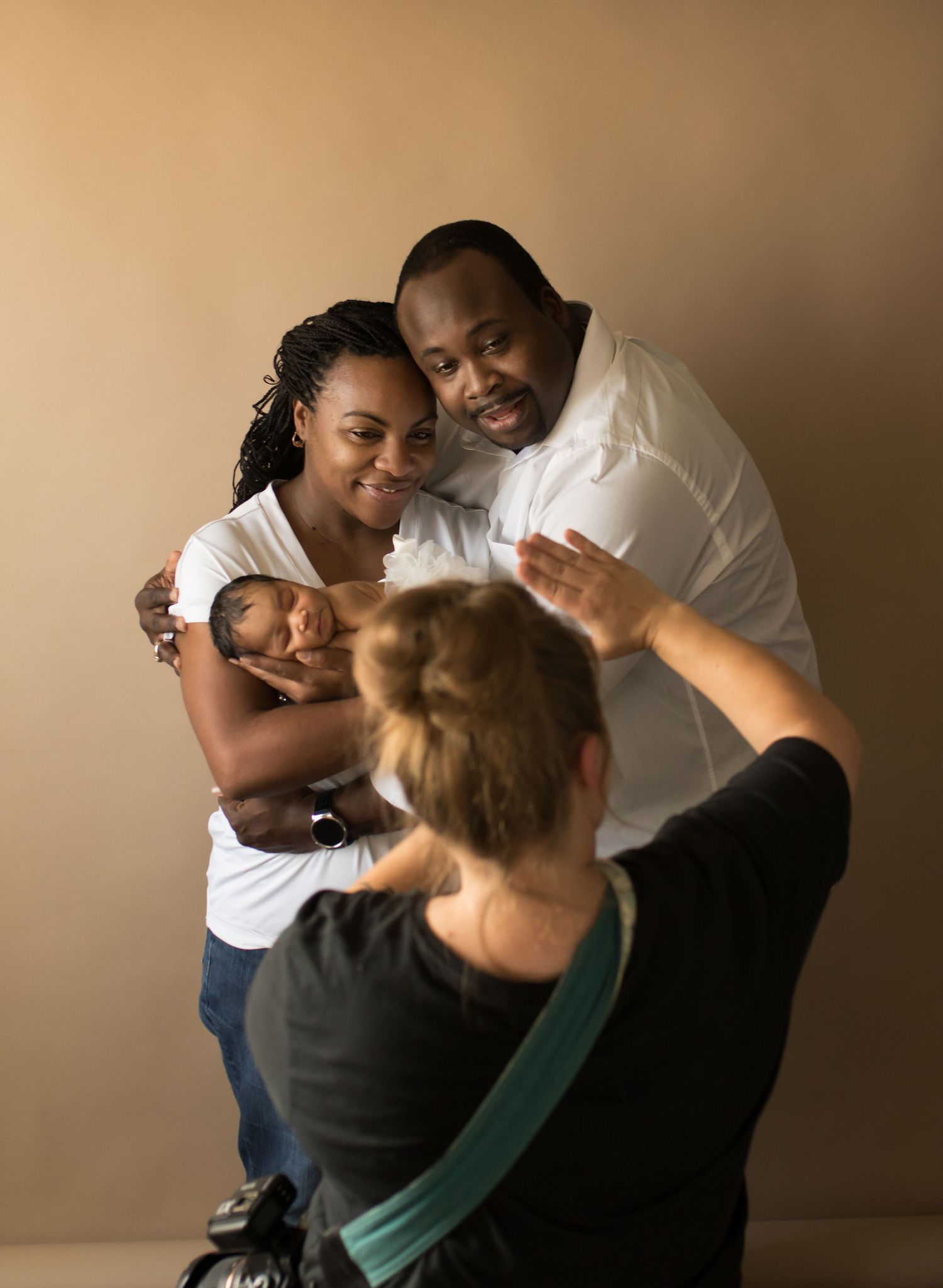 Behind-the-scenes photo of a photographer capturing a tender moment during a studio portrait session.
