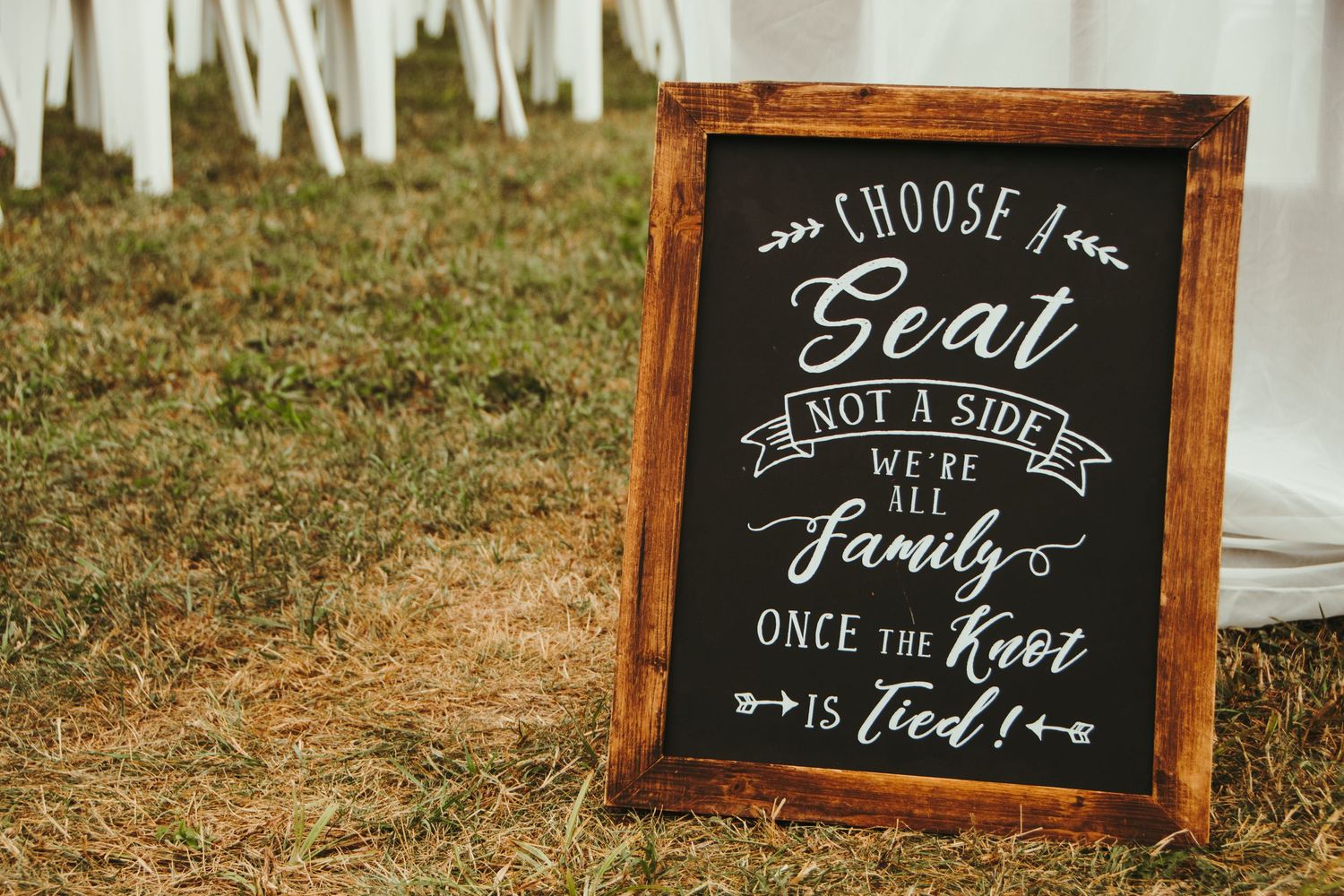 Rustic chalkboard wedding sign reading choose a seat not a side we are all family.