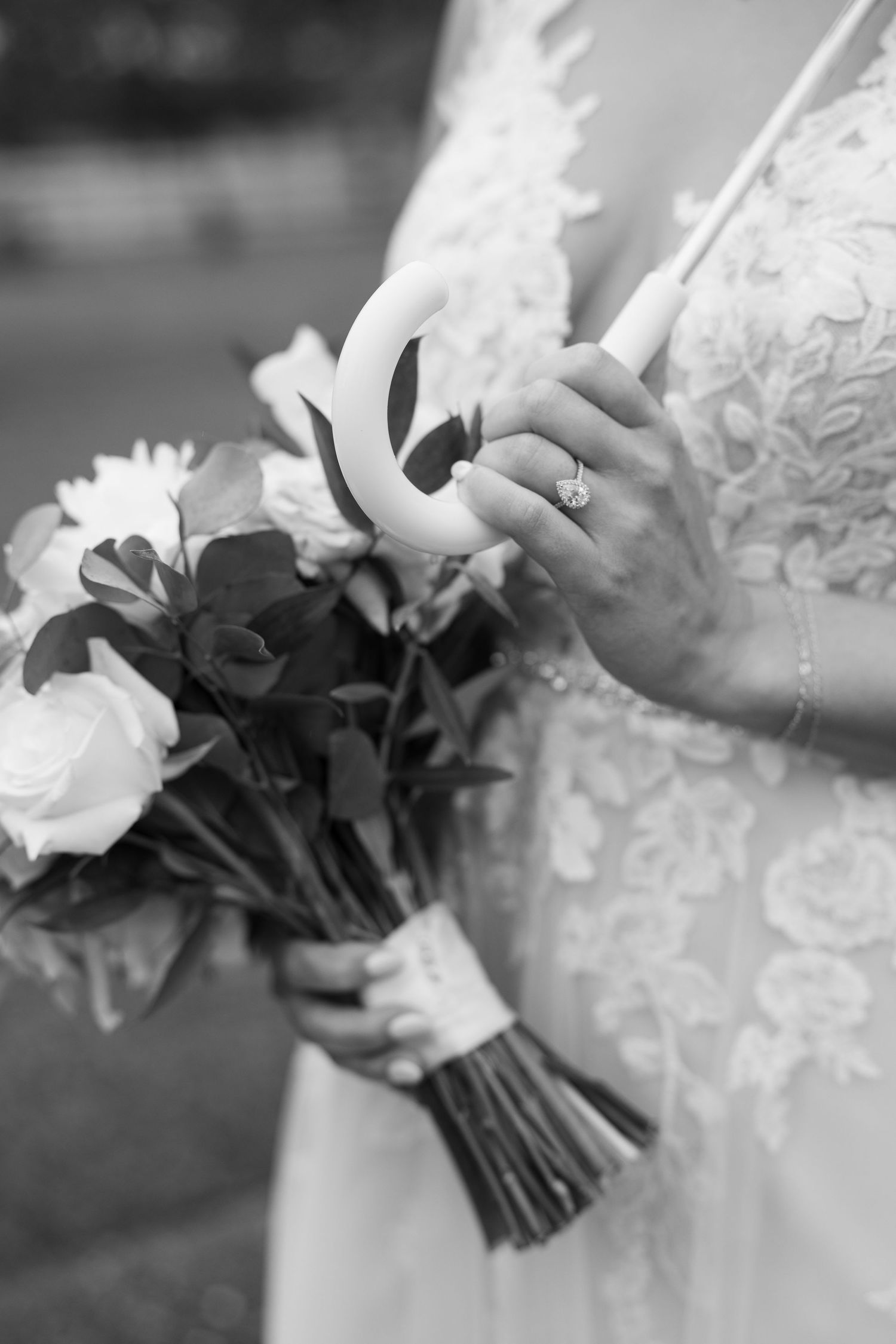 Close-up black and white photo of bridal bouquet and lace dress details in Nashville TN