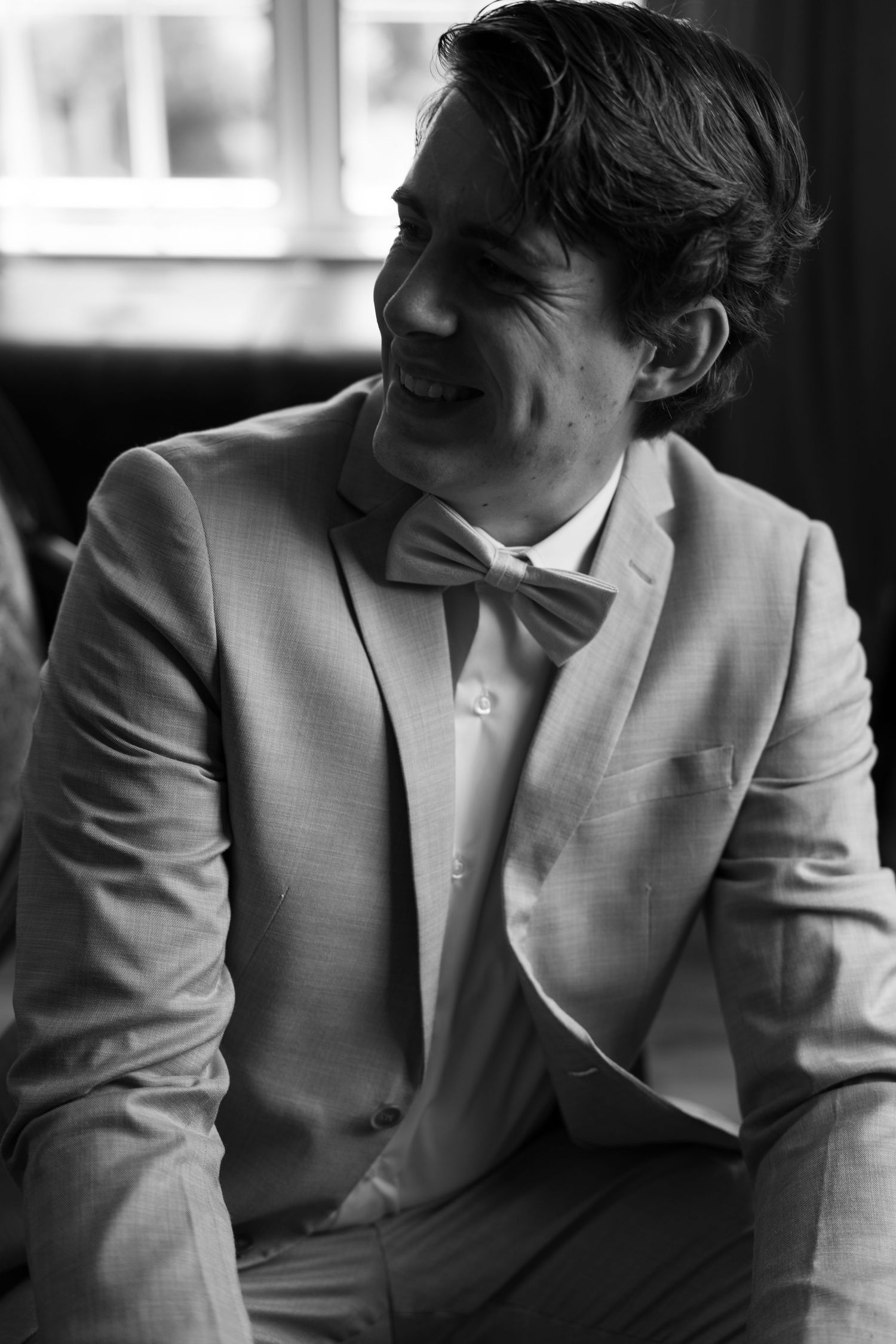 Black and white sequence of photos showing person in light suit jacket with hand gestures in natural poses.