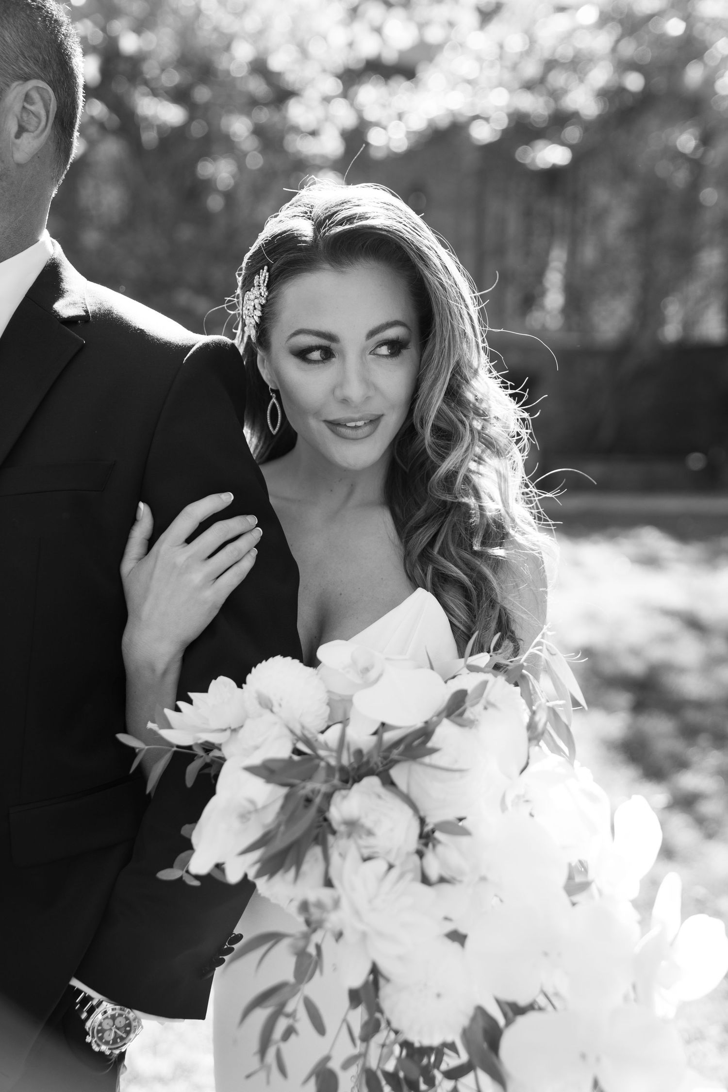 A black and white wedding photo collage shows romantic close-up shots with delicate white flowers Nashville TN