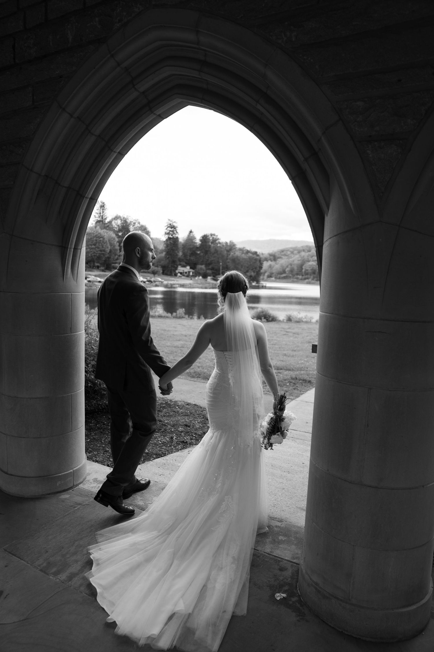 Dramatic black and white sequence through stone archways captures flowing wedding dress movement.