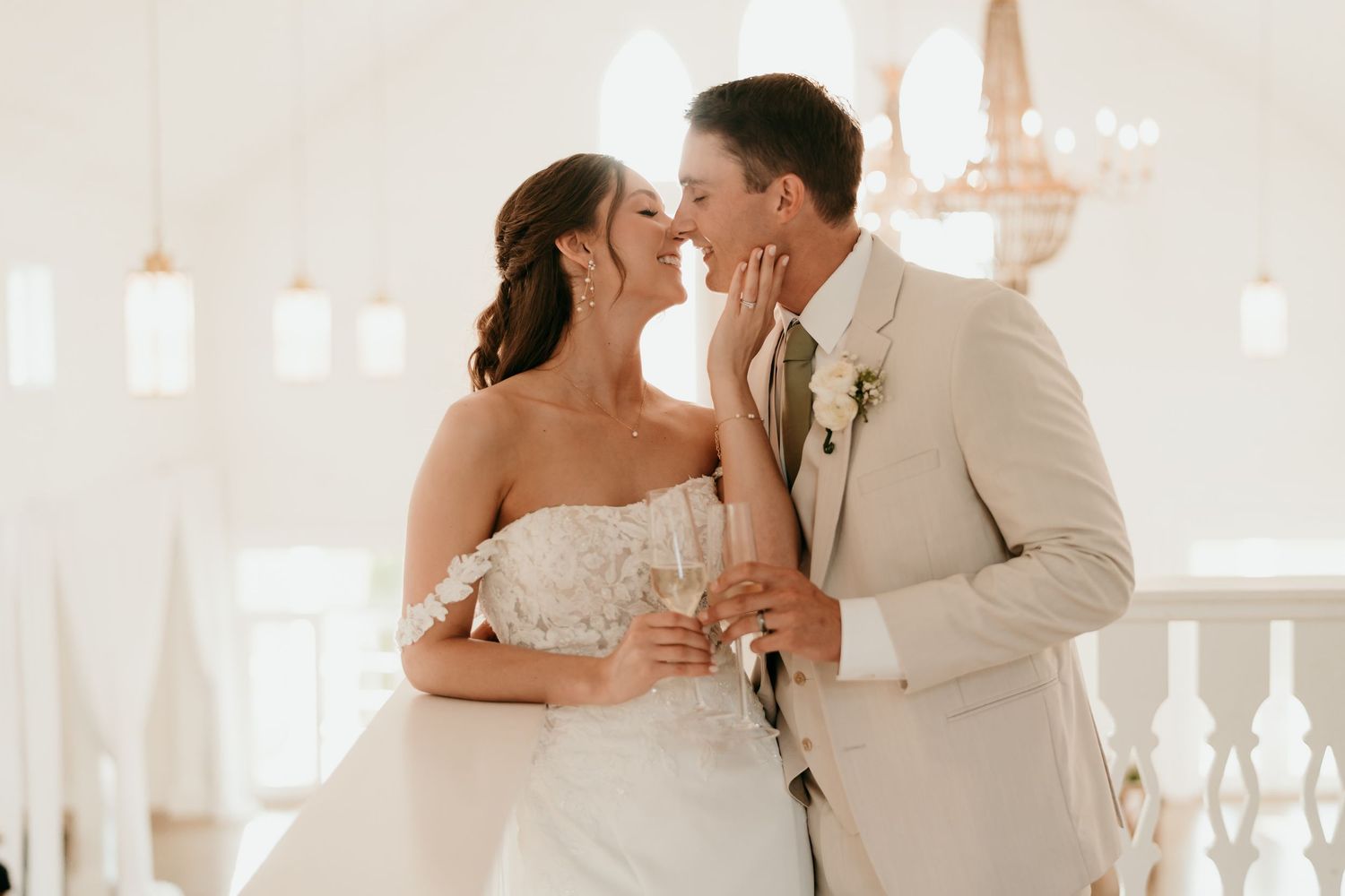 Light and airy reception hall captures tender moment between newlyweds.