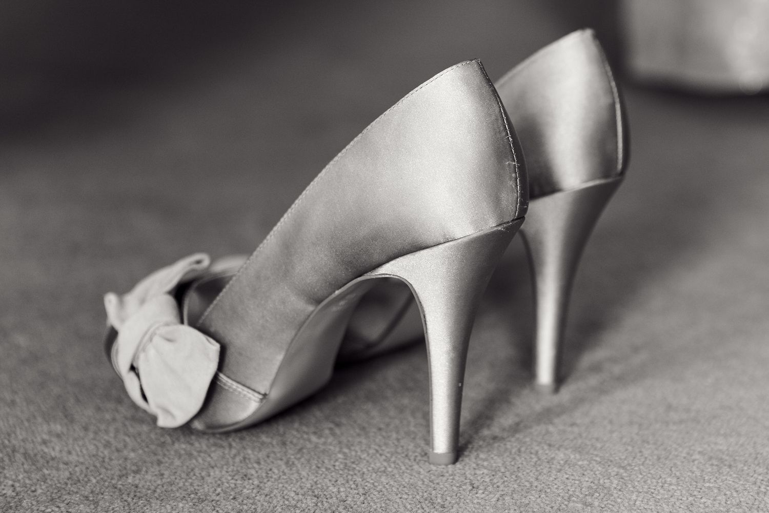 Elegant silver bridal shoes arranged in a row at wedding near Woodbridge, Suffolk.