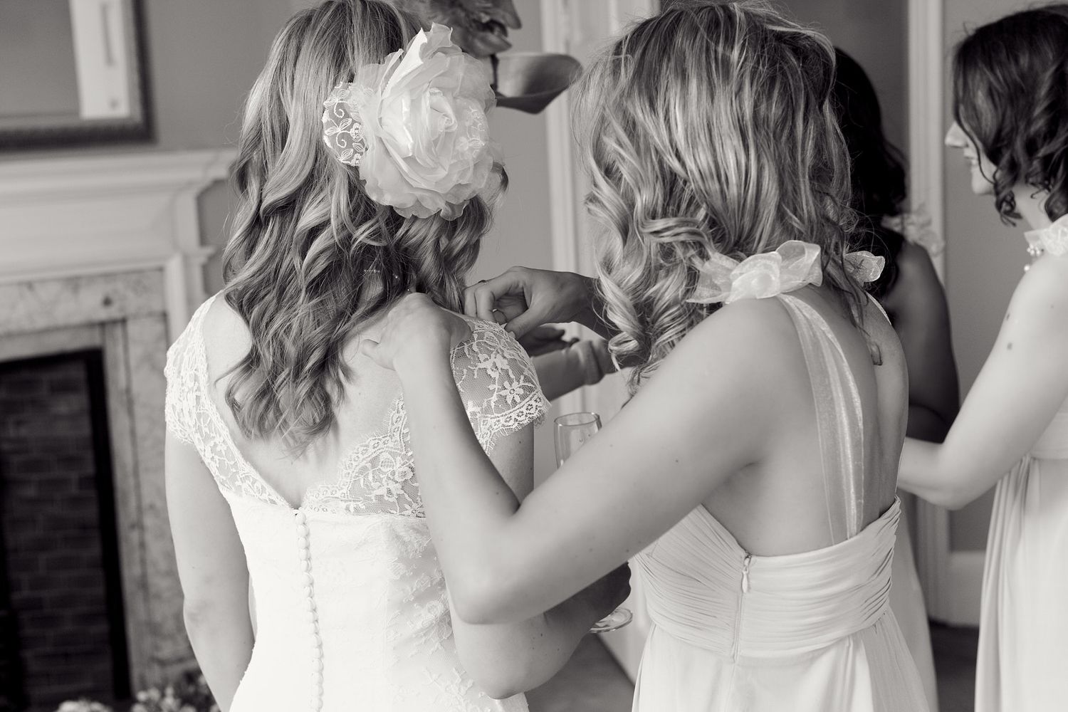 Close-up details of lace wedding dress backs and hair styling.