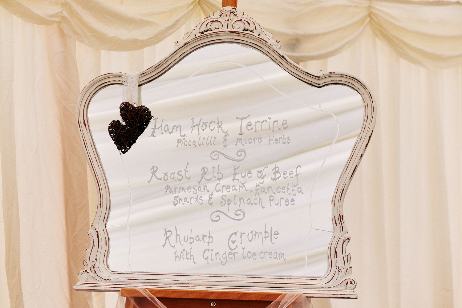 Elegant white decorative wall signs with ornate silver frames at wedding venue.