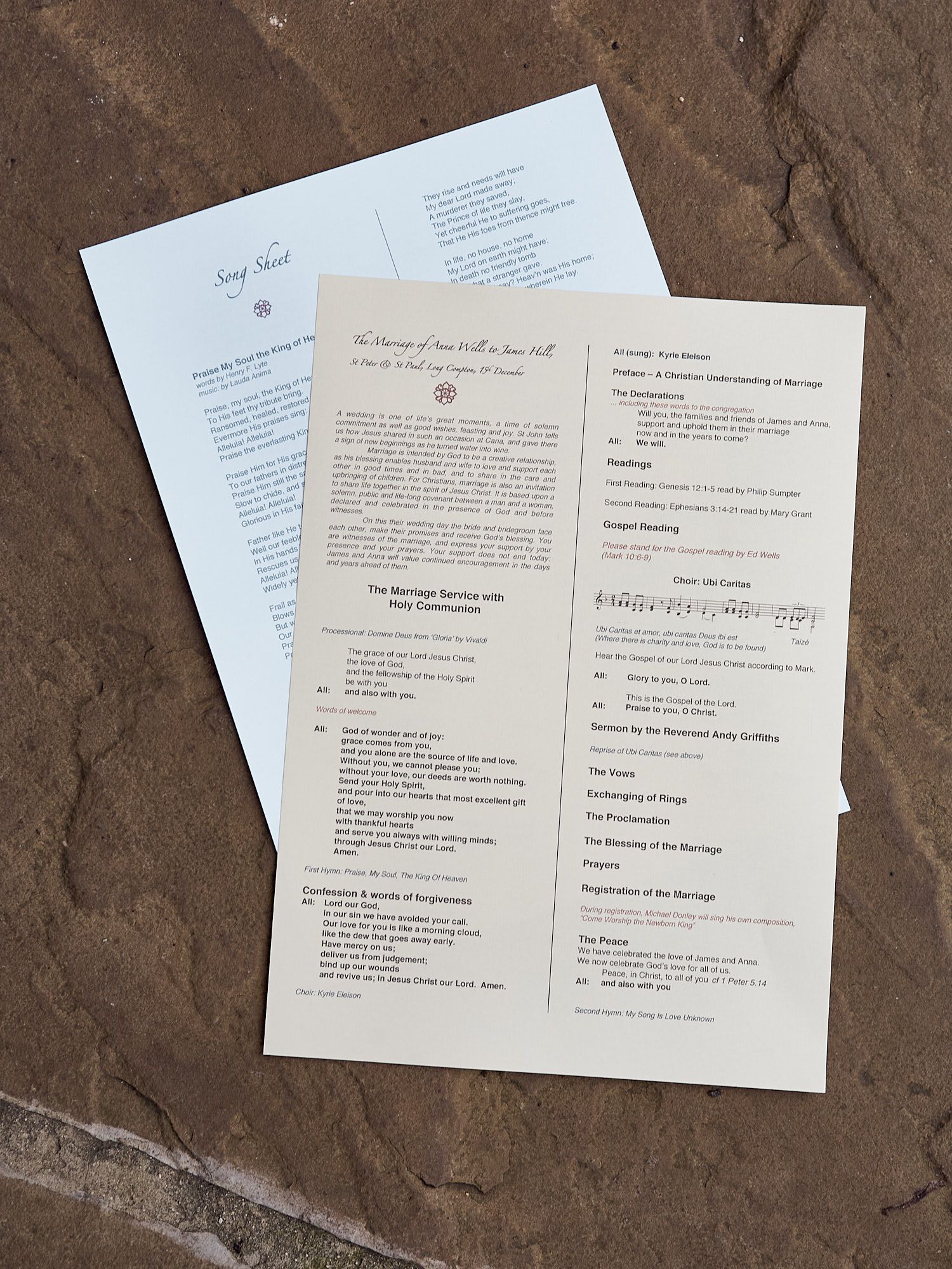 Wedding ceremony programs laid out on textured stone surface at a reception in East Sussex.