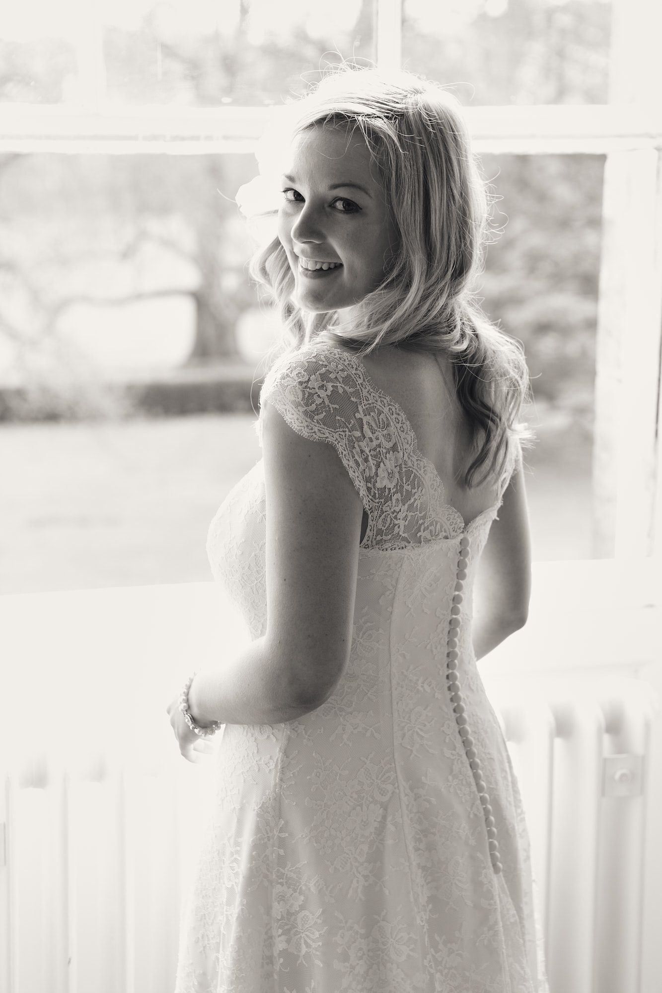 Sequence of candid bridal portraits in front of window with soft natural lighting.