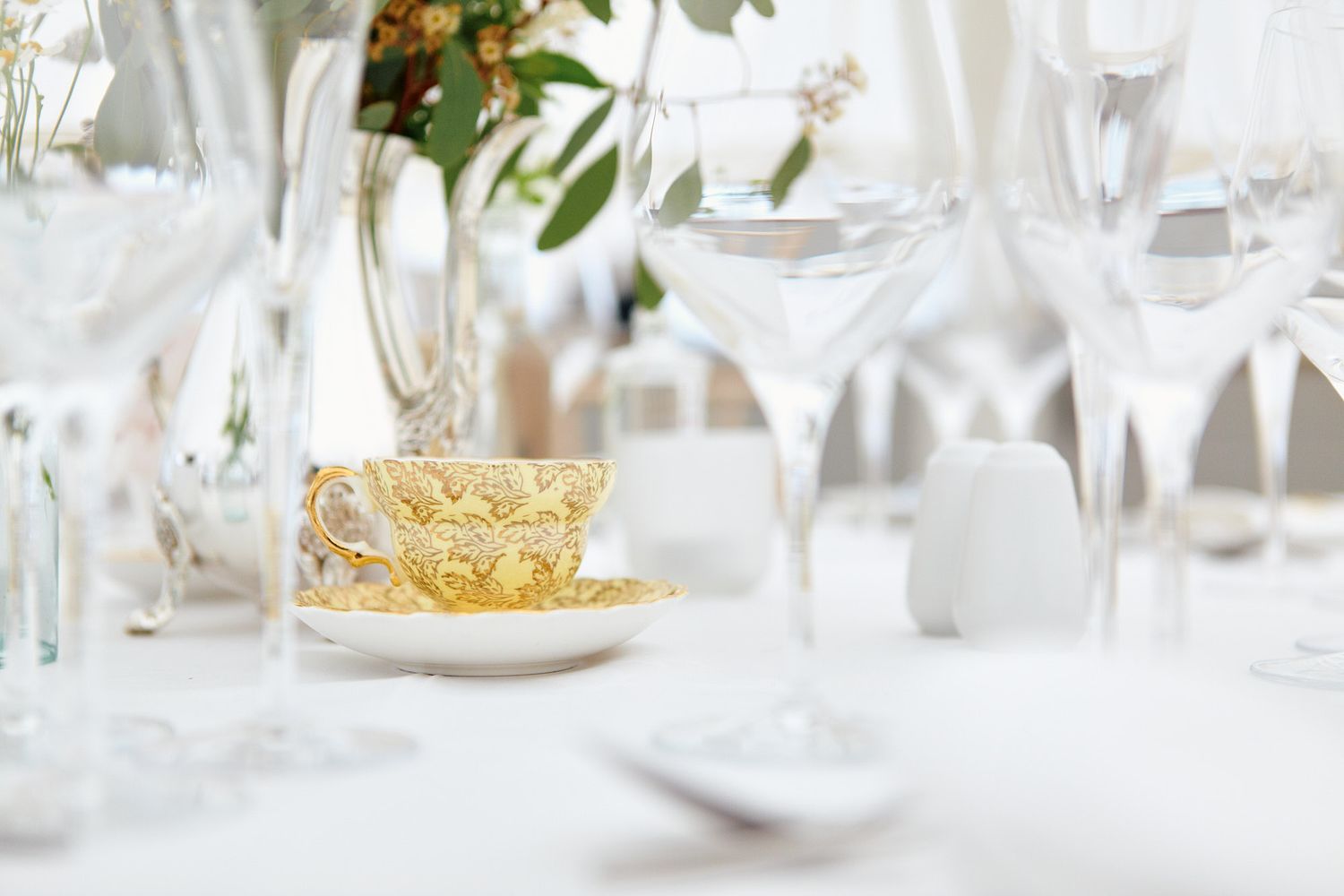 Elegant wedding table setting with crystal glassware and white linens at wedding in central London.