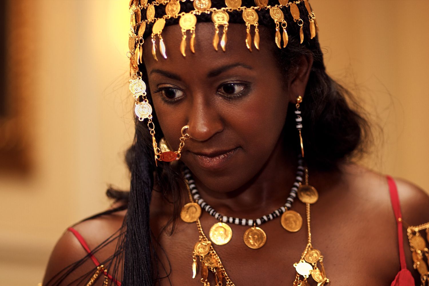 Close-up shots showcase ornate gold jewelry and accessories against warm lighting at Institute of Directors in London.