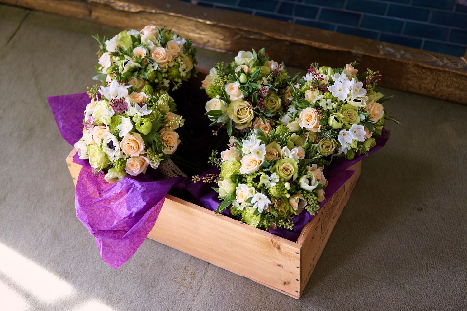 Rustic wooden boxes filled with cream and blush floral arrangements at wedding in Lewes, Sussex.