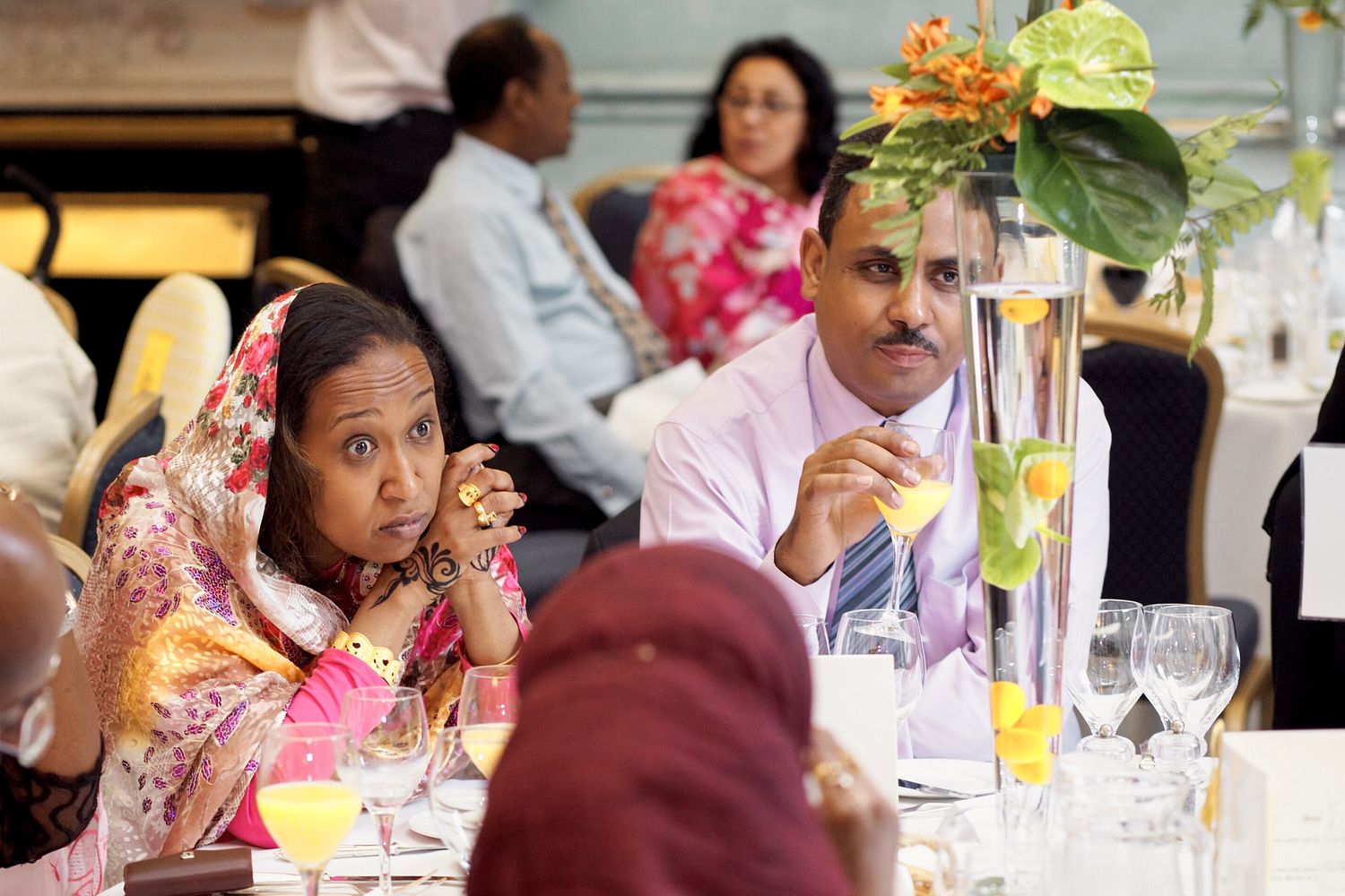 Wedding reception table with guests enjoying dinner and conversation at Institute of Directors in London.