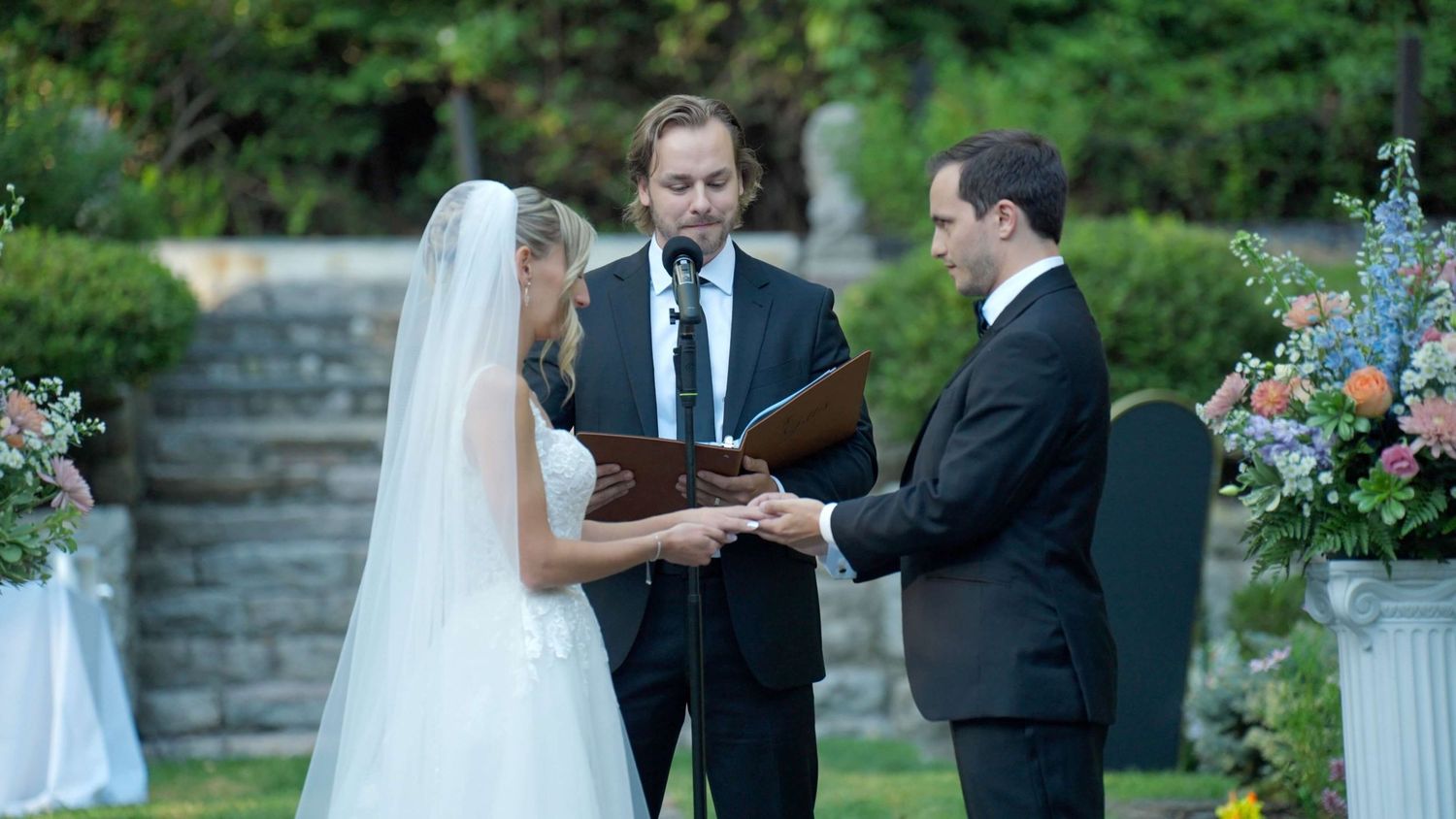 Close-up of bride and groom exchanging vows during outdoor Arrow Park wedding ceremony.