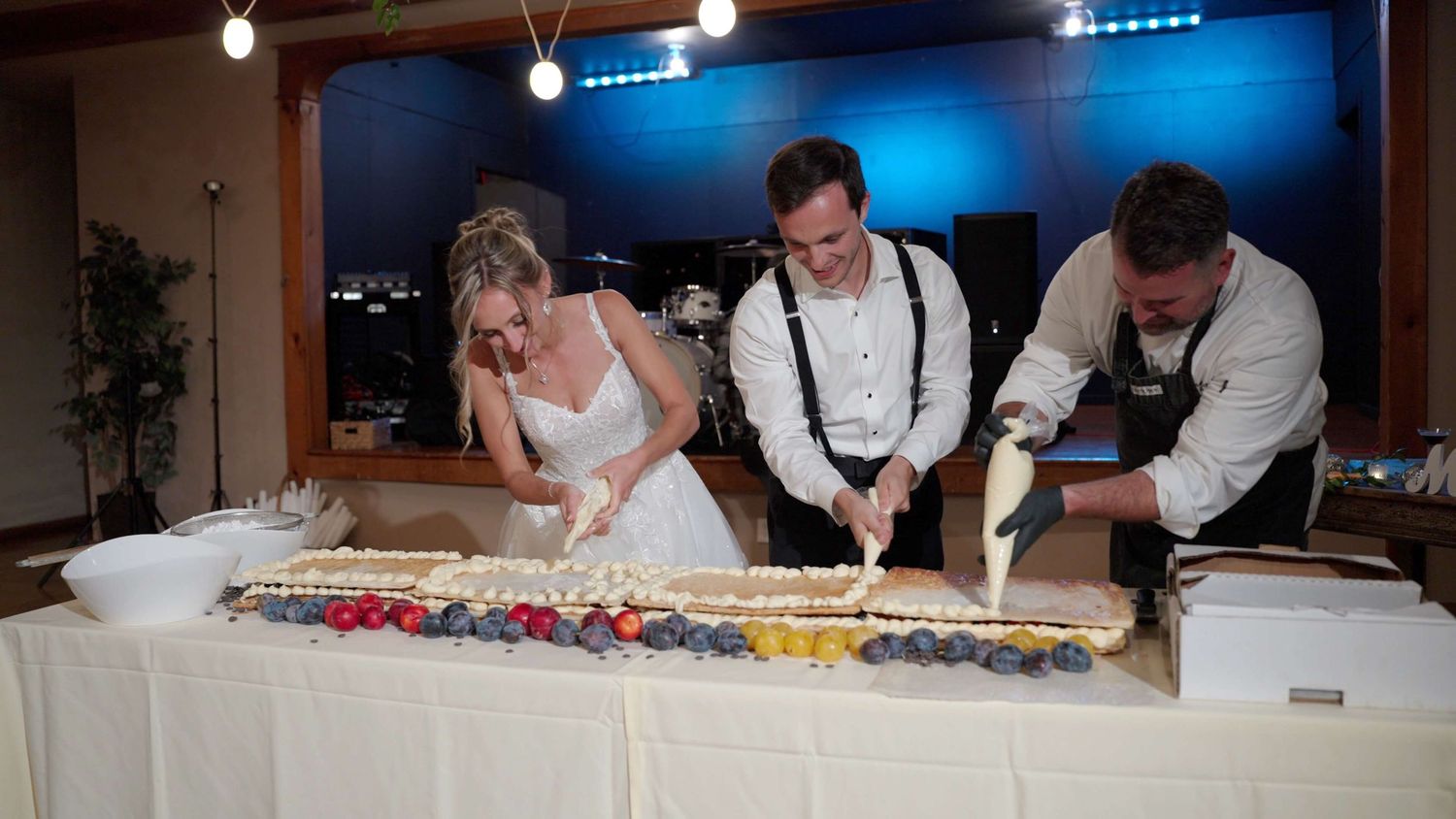 Couple creating wedding cake live with Chef  Anthony Mario at Arrow Park reception 2.