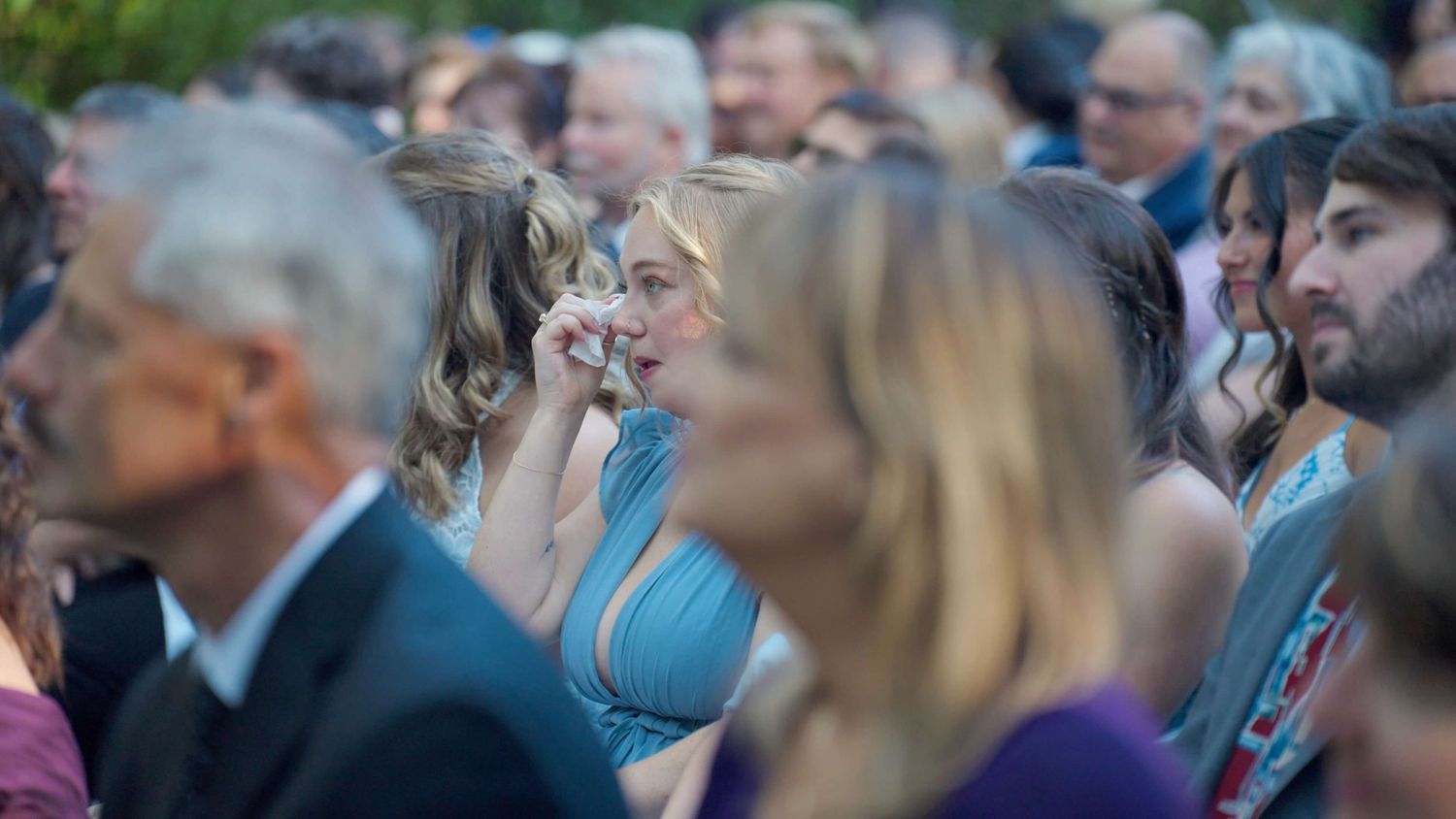 Guest crying during emotional ceremony during outdoor Arrow Park wedding