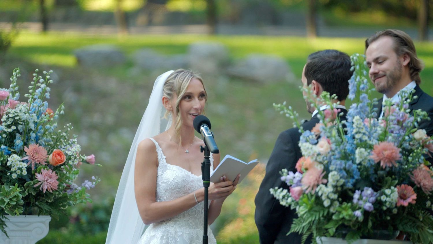 Bride sharing vows during outdoor Arrow Park wedding ceremony.