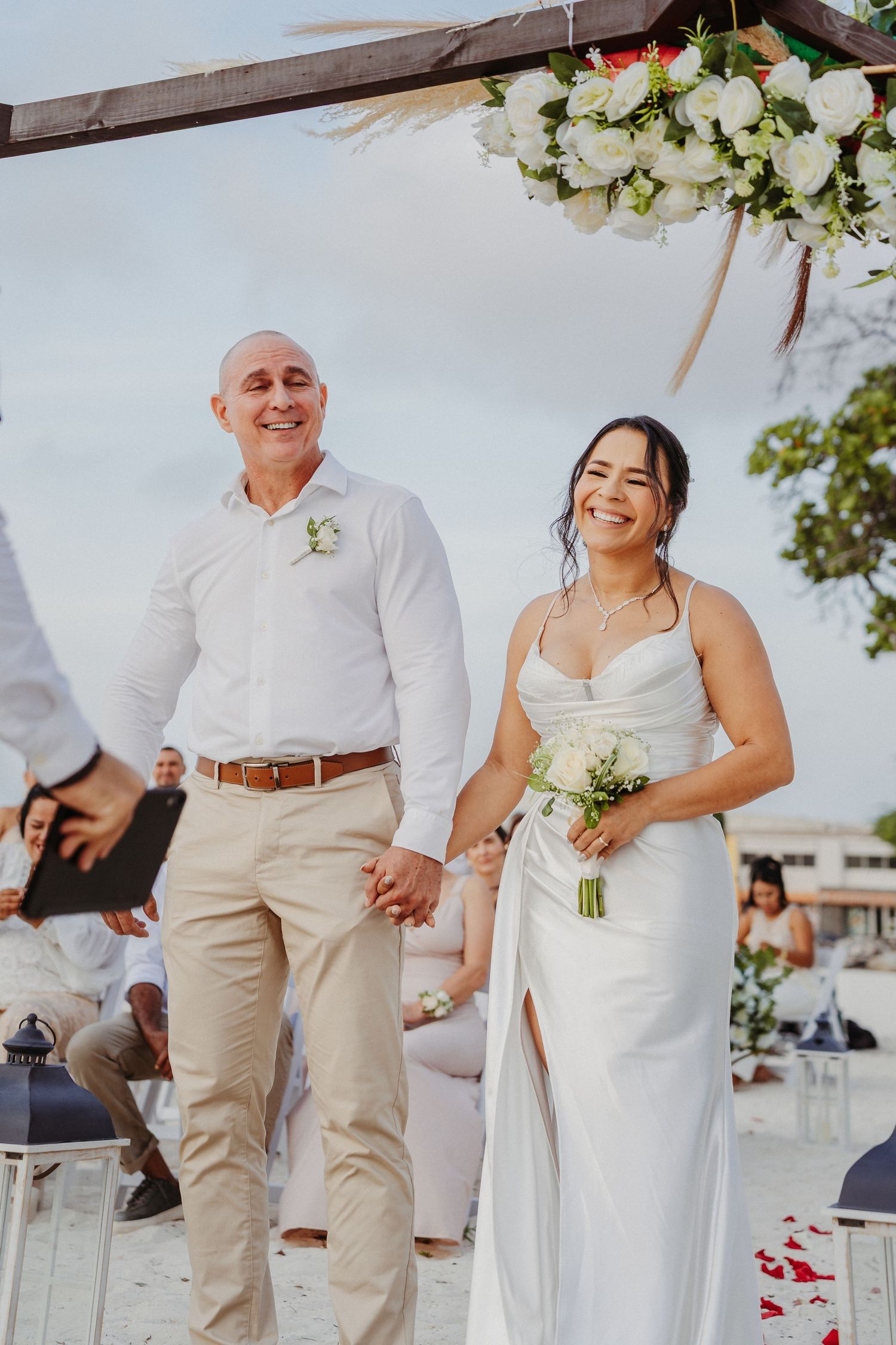 A series of candid wedding photos showing joyful moments between people in white and beige attire on a sunny day.