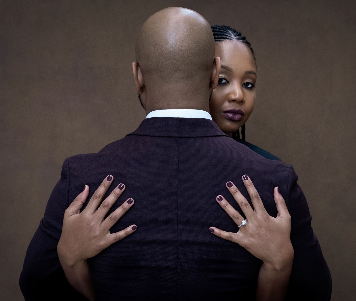 A romantic couple in formal attire embracing in a series of intimate poses against a dark background.