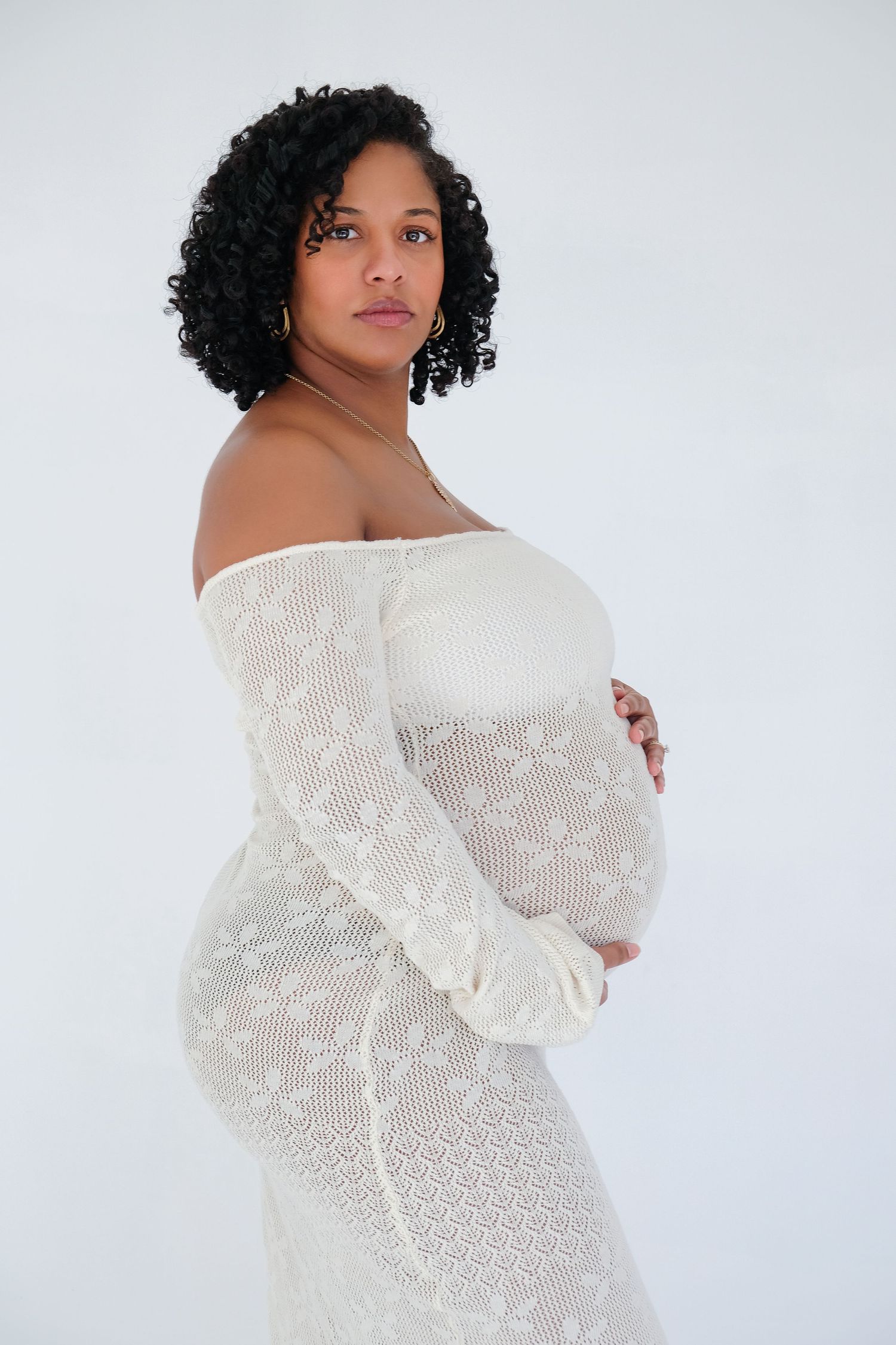 A model in a white off-shoulder sweater poses against a light background in a series of elegant portraits.