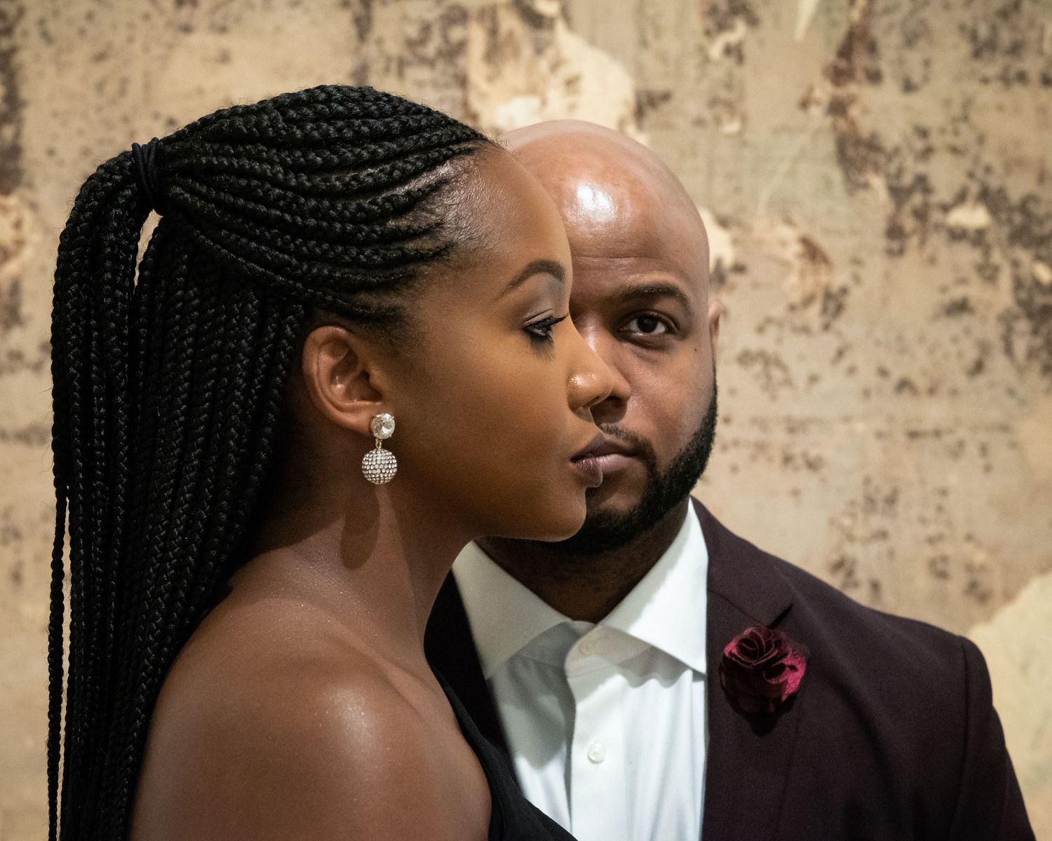 Stylish couple in formal attire sharing intimate moments in a romantic photo sequence.