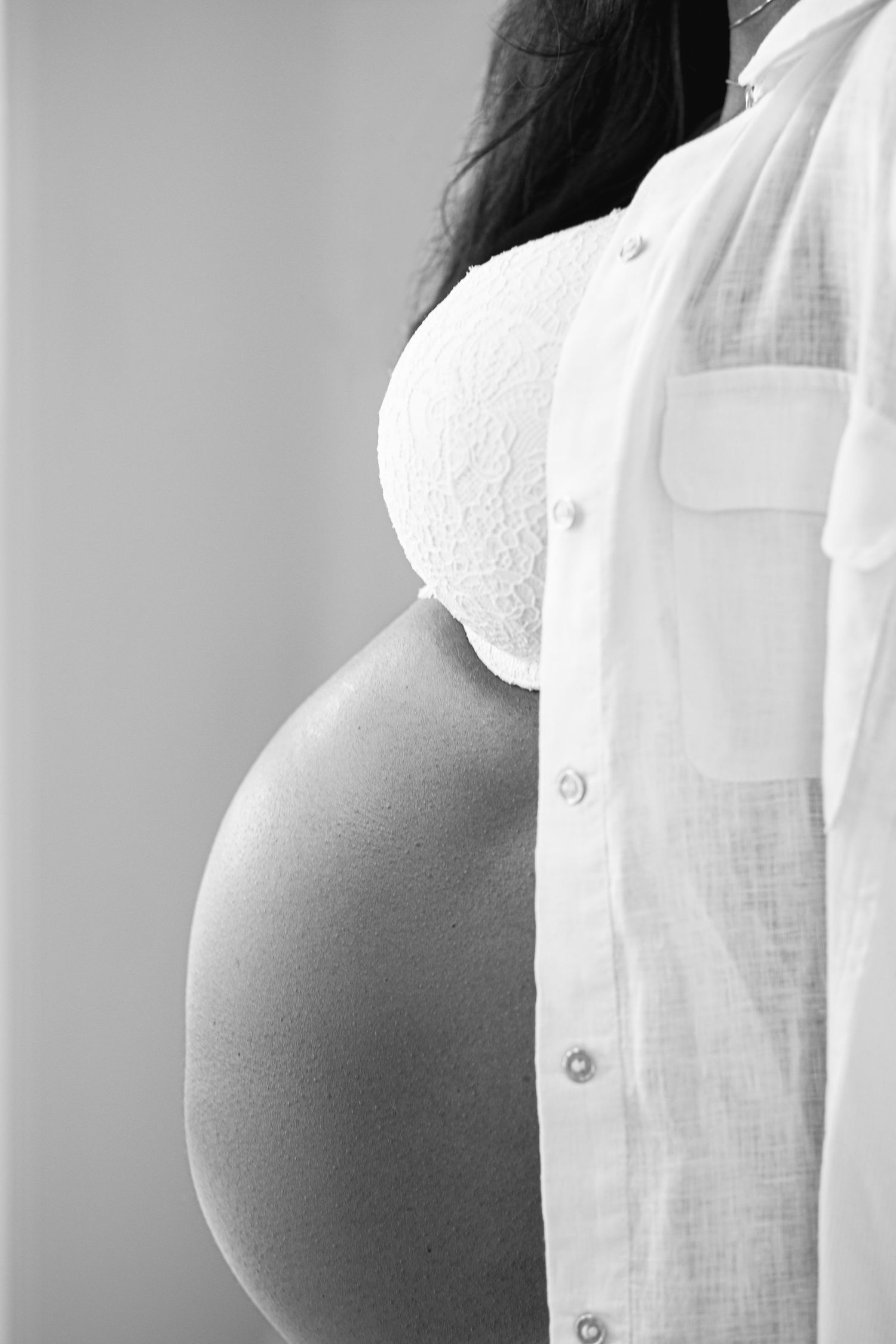 A series of abstract black and white photographs showing curved silhouettes against a light background.
