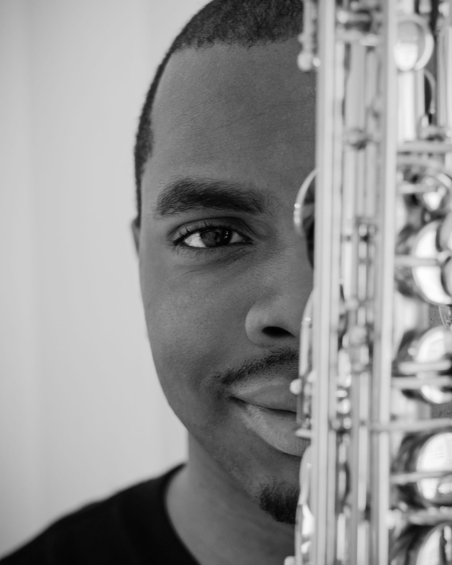 A series of black and white portrait photos showing partial views of someone's face against a light background.