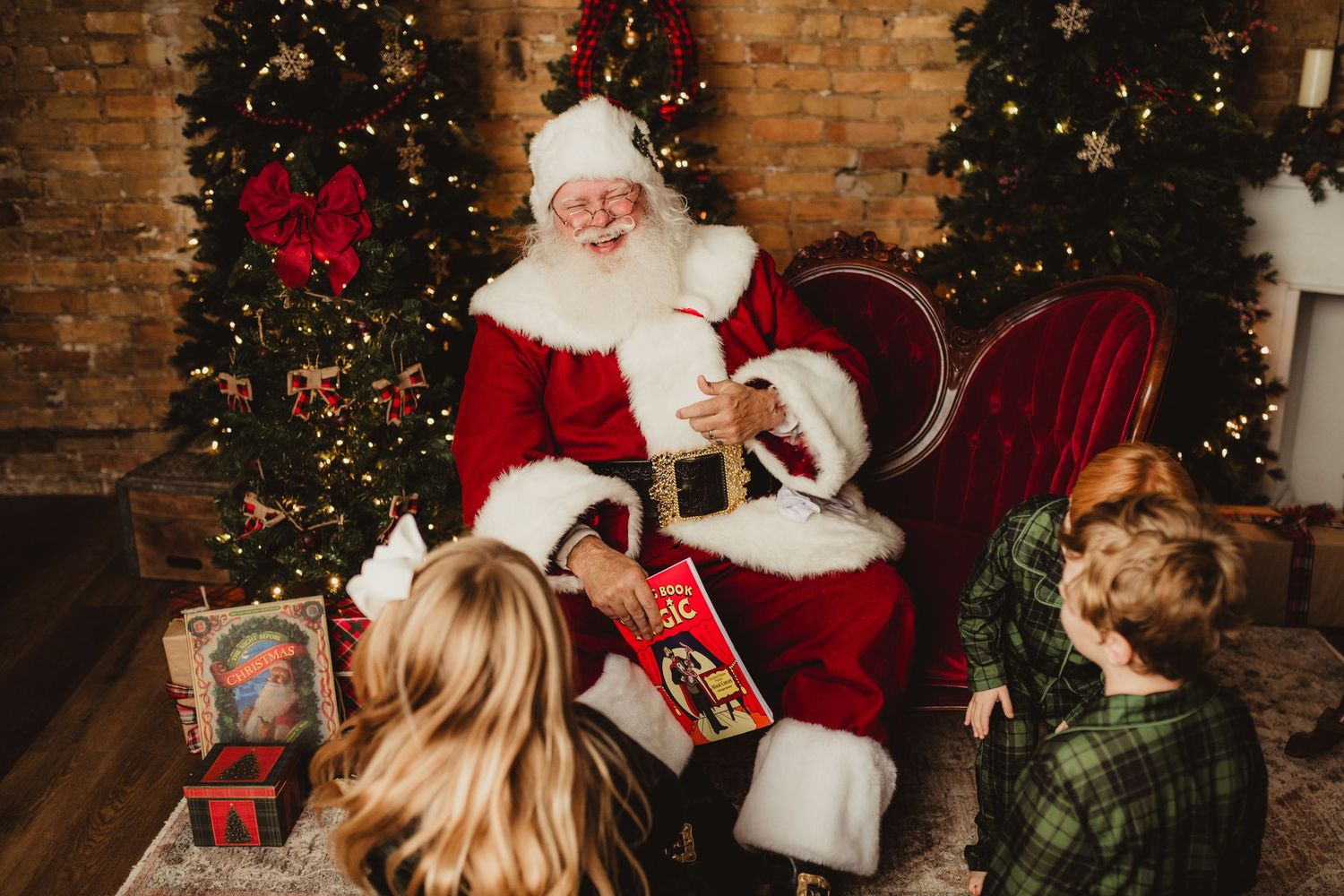 Festive holiday scene with Santa Claus meeting children by decorated Christmas trees.
