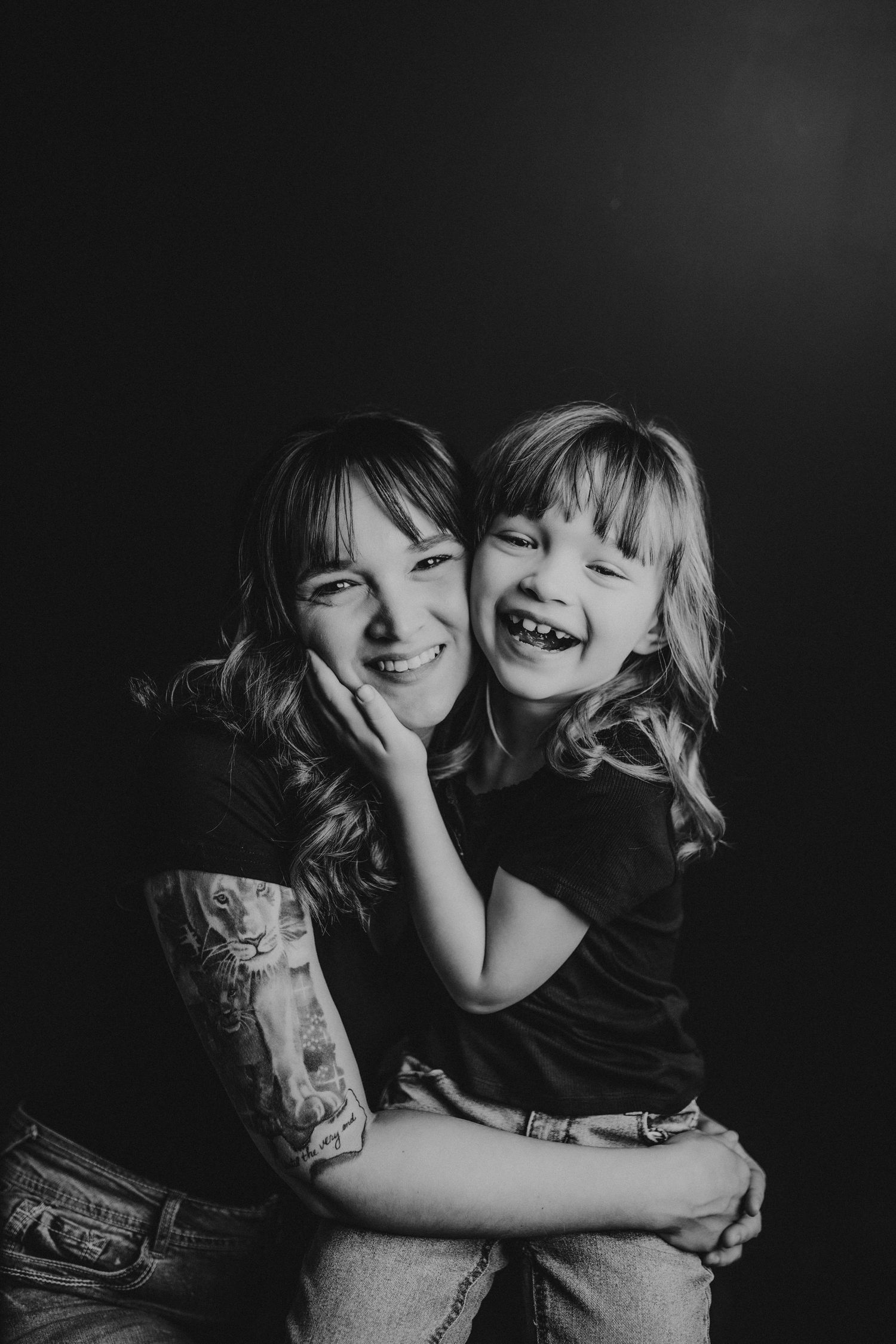 Black and white portrait of joyful mother and child sharing intimate moment.