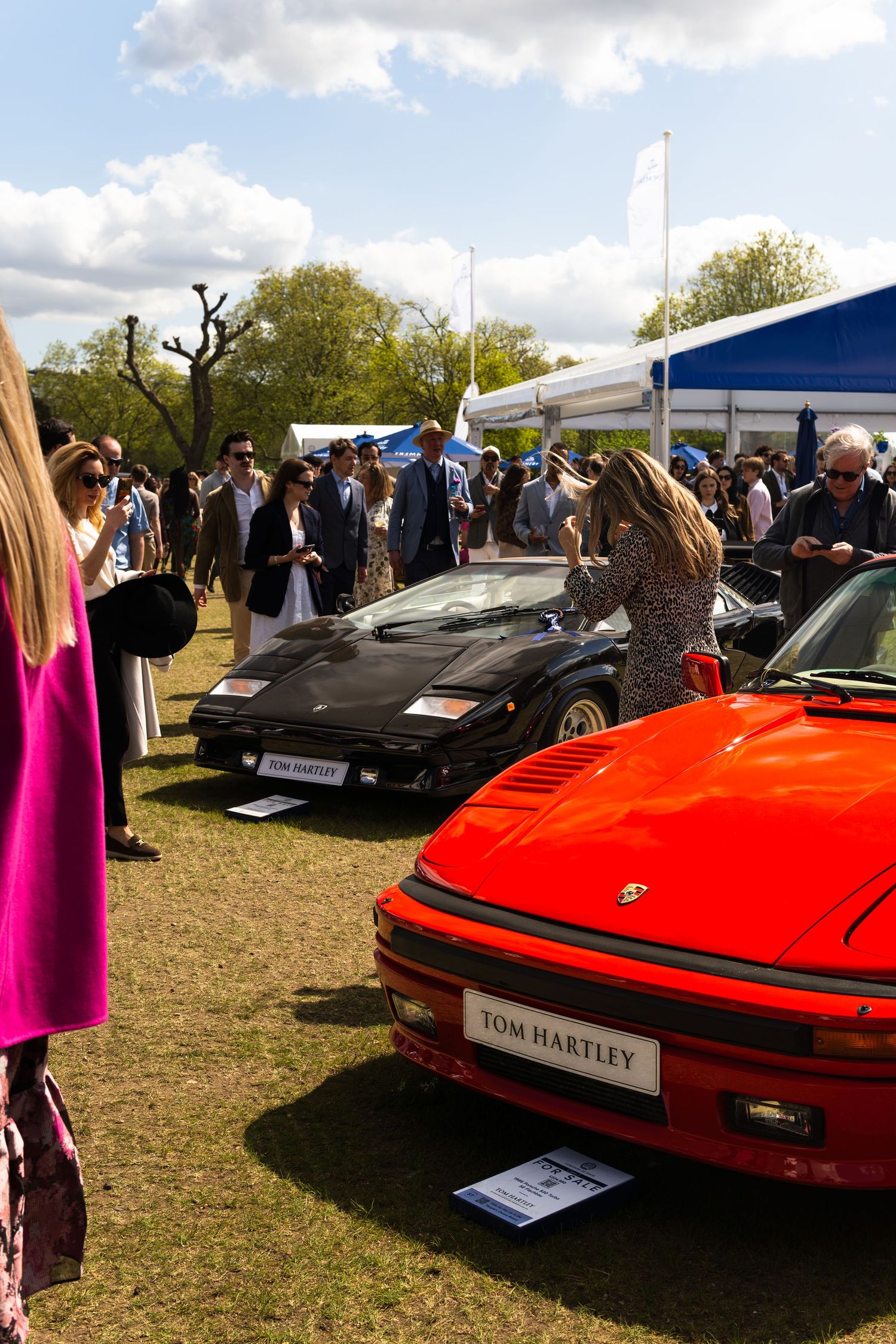 Tom Hartley classic car display featuring red Porsche 930 Turbo and black Lamborghini Countach at outdoor show.