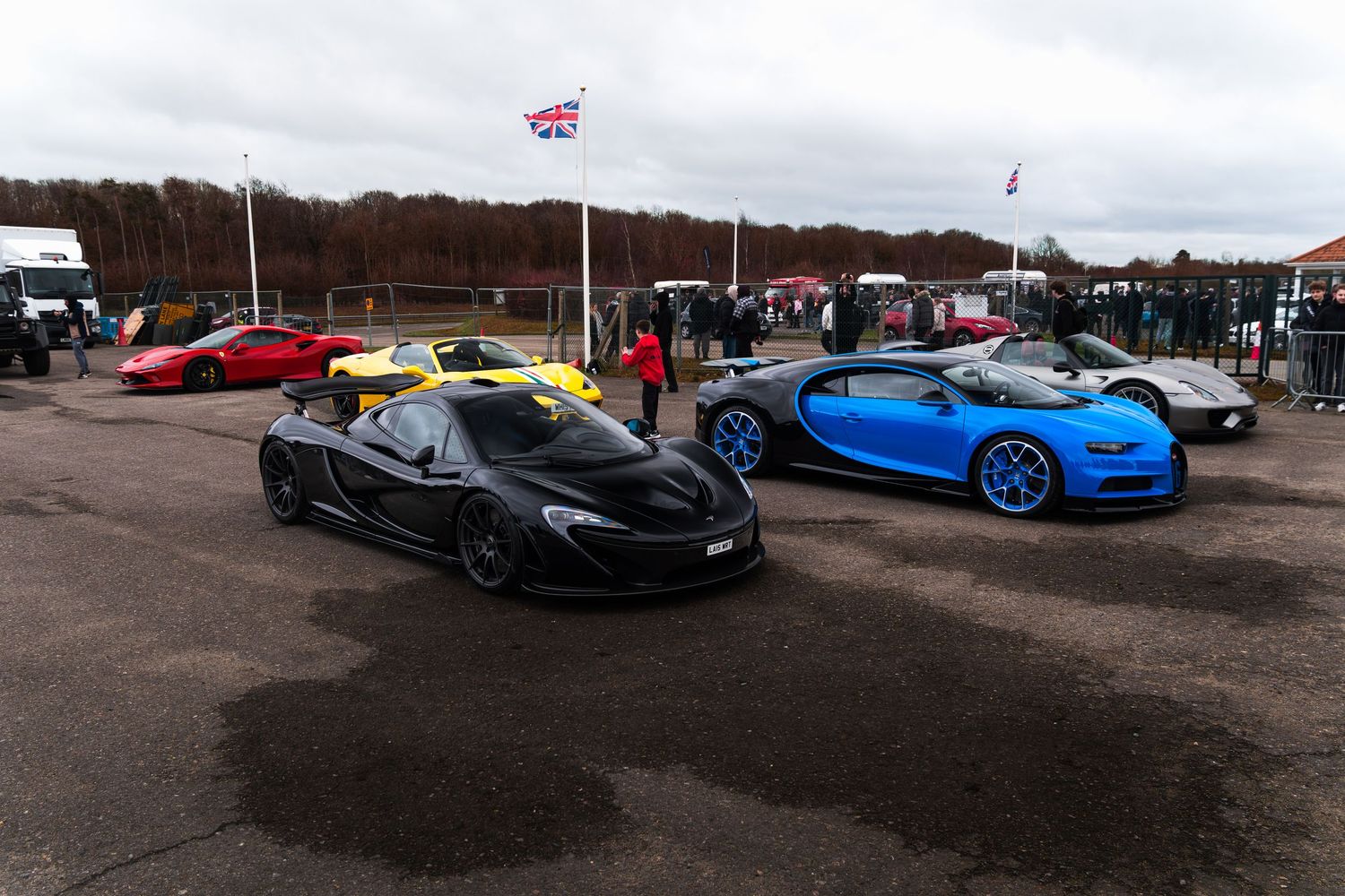 Black McLaren P1 and blue Bugatti Chiron lined up at a UK supercar meet event.