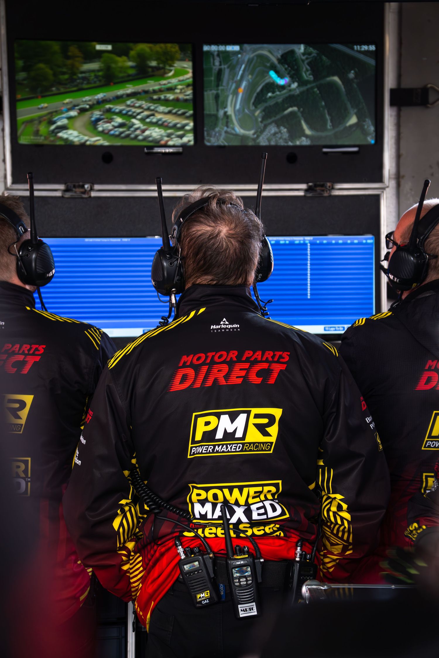 Motor Parts Direct PMR Power Maxed Racing team engineers monitor race data on screens in the pit lane.
