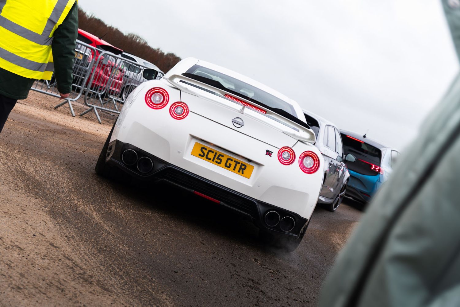 White Nissan GT-R with SC15GTR number plate at a UK outdoor car show event.