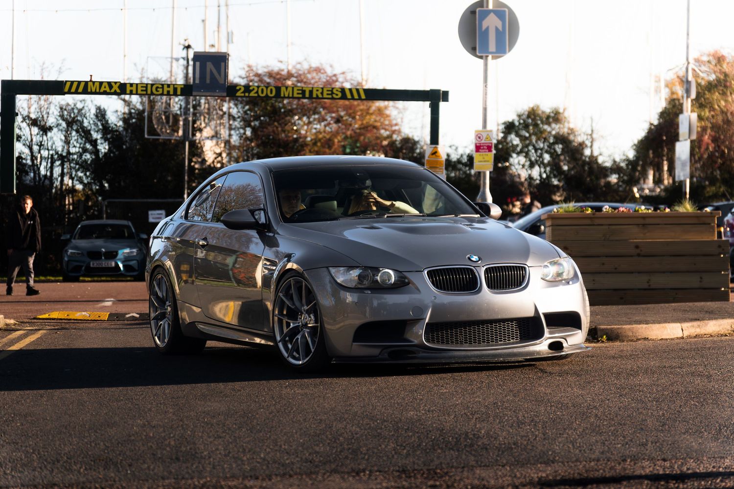 Silver BMW M3 E92 coupe parked at a motorsport drag strip event.