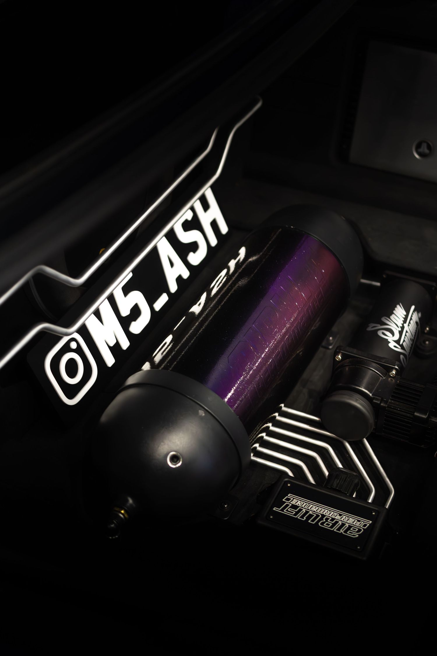 Purple performance air intake with M5_ASH Instagram handle on a custom BMW engine bay.