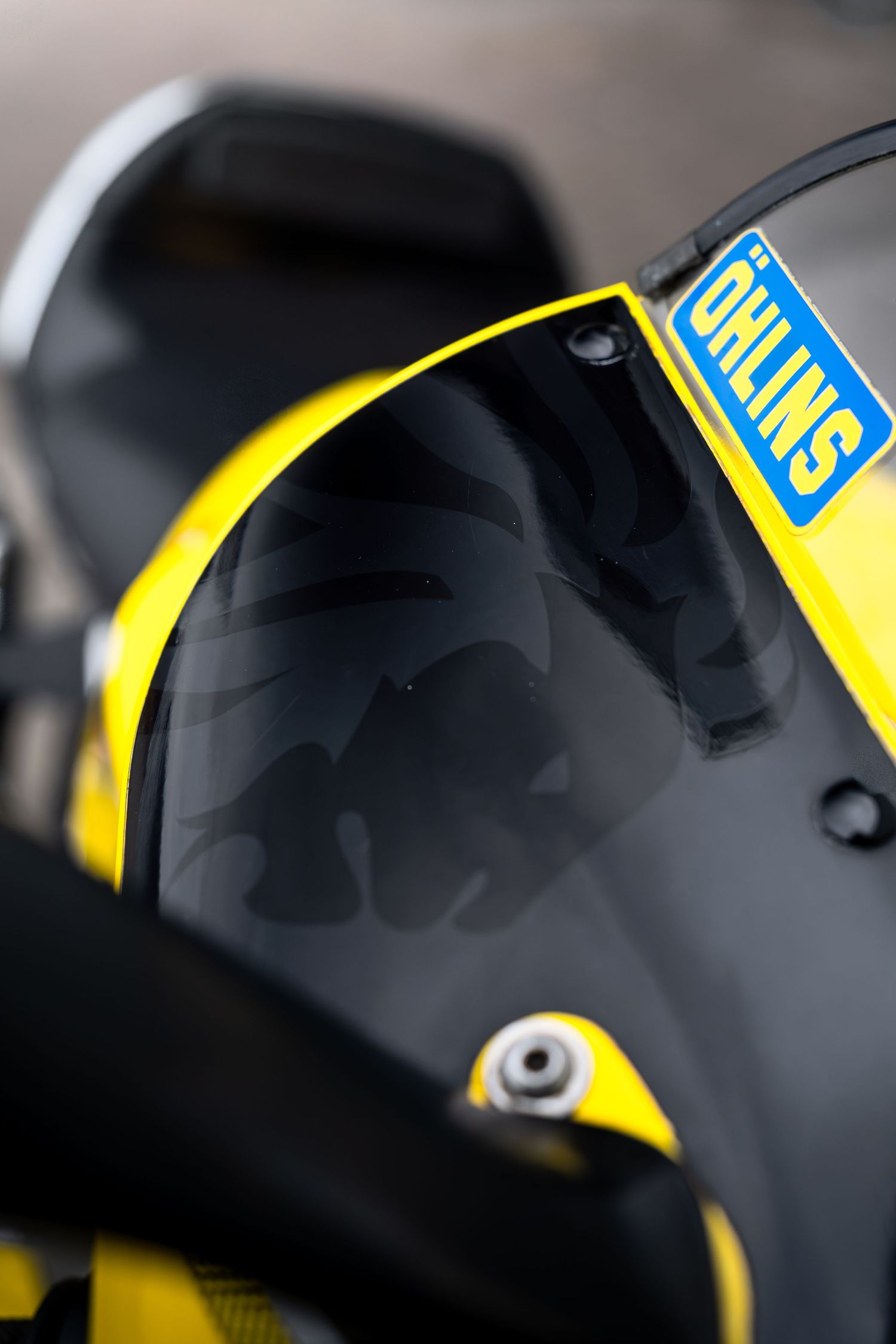 Ohlins sticker on the rear fairing of a yellow and black sport motorcycle.